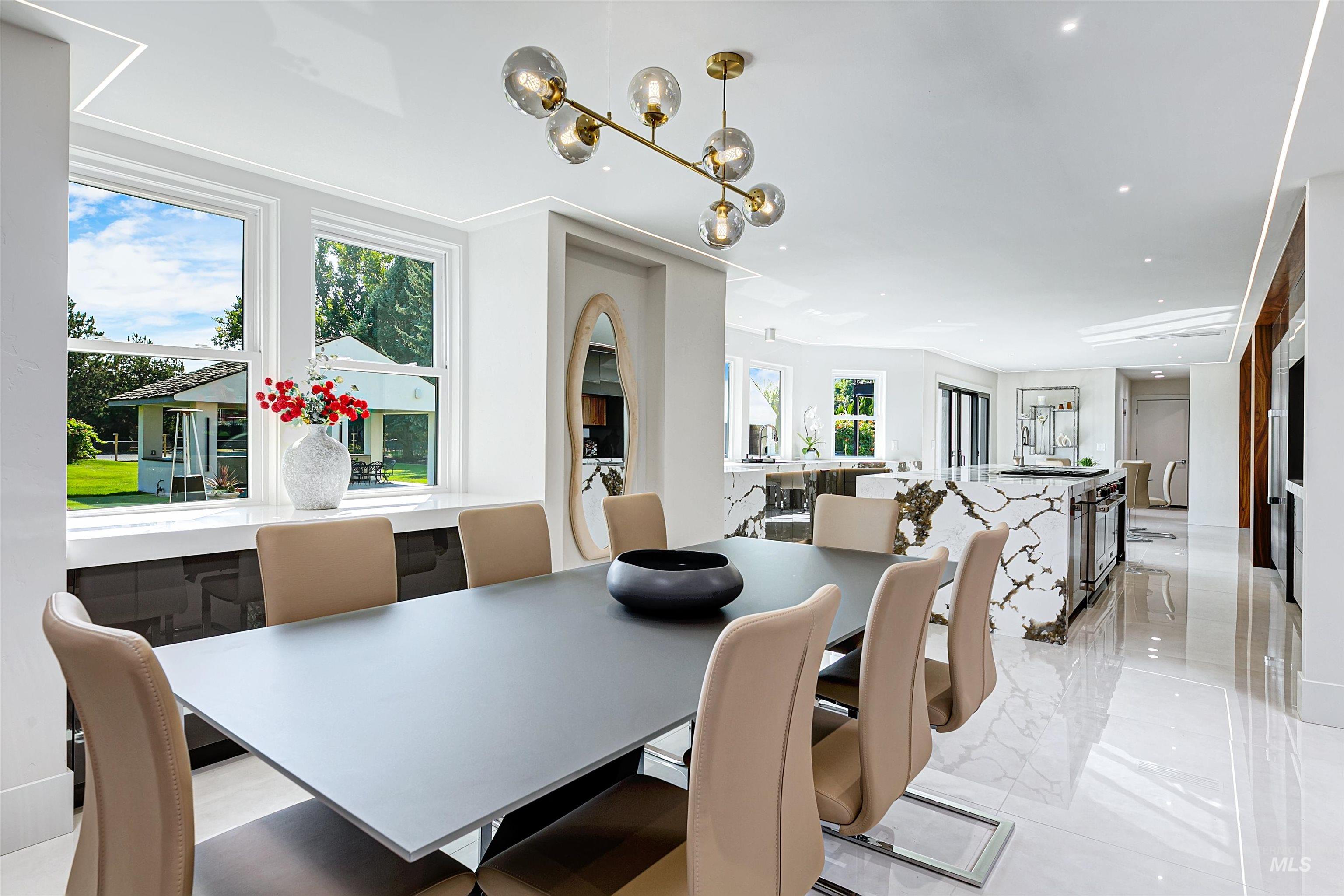 Dining area with chandelier and outdoor view.