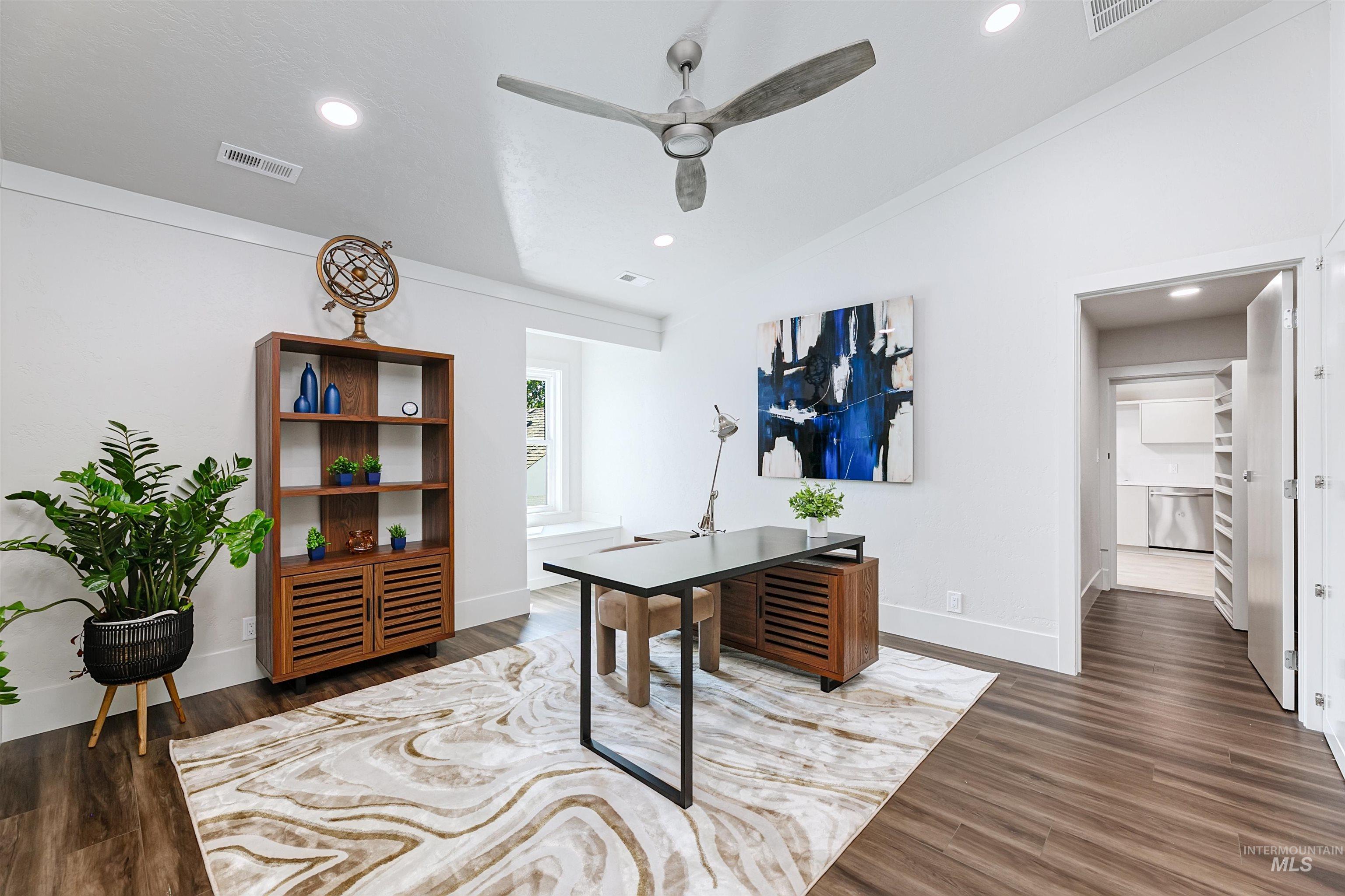 Home office or bedroom with vaulted ceiling, recessed lighting, dark wood-style floors, and ceiling fan.