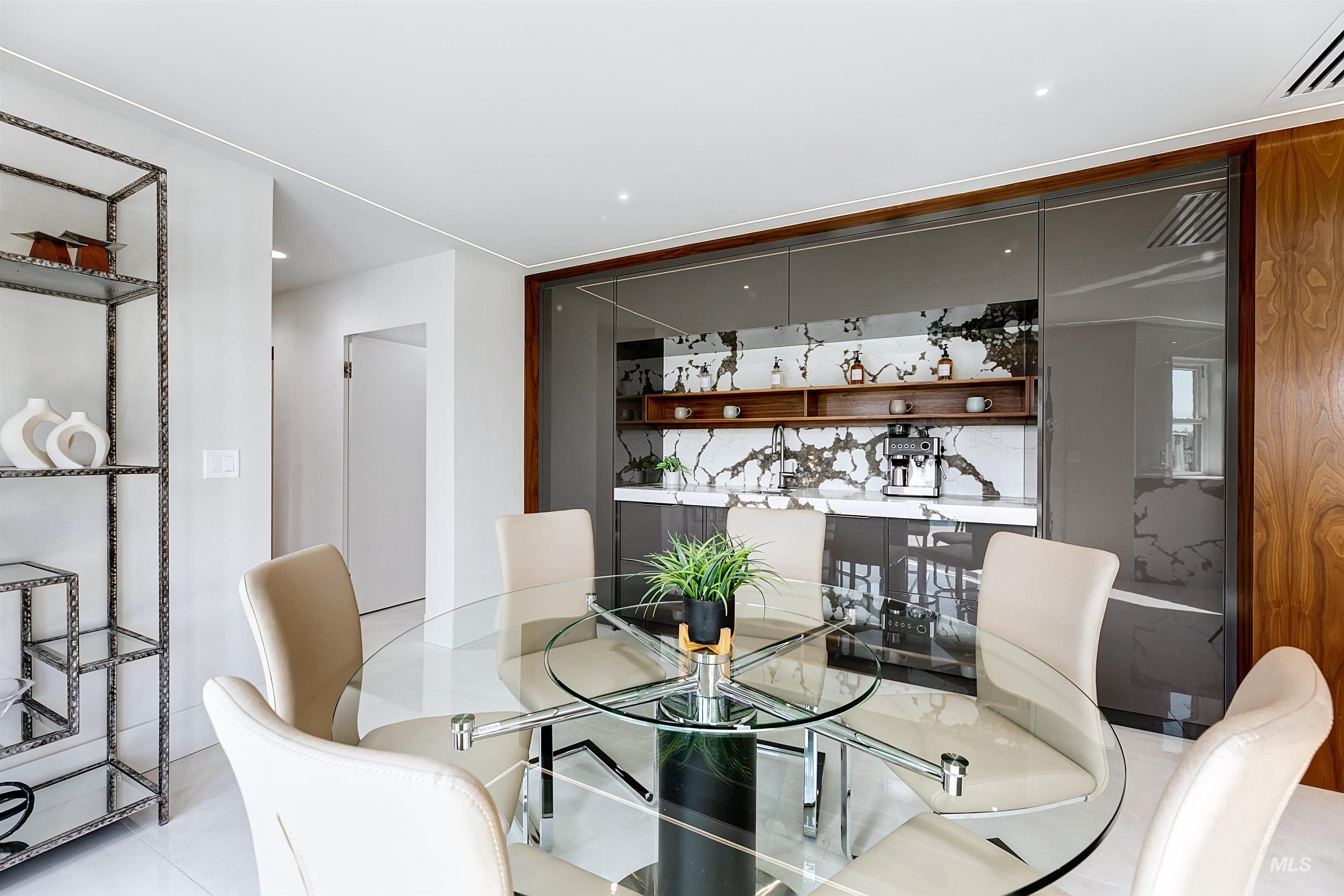 Informal dining room with full coffee bar, light tile patterned flooring, and recessed lighting.