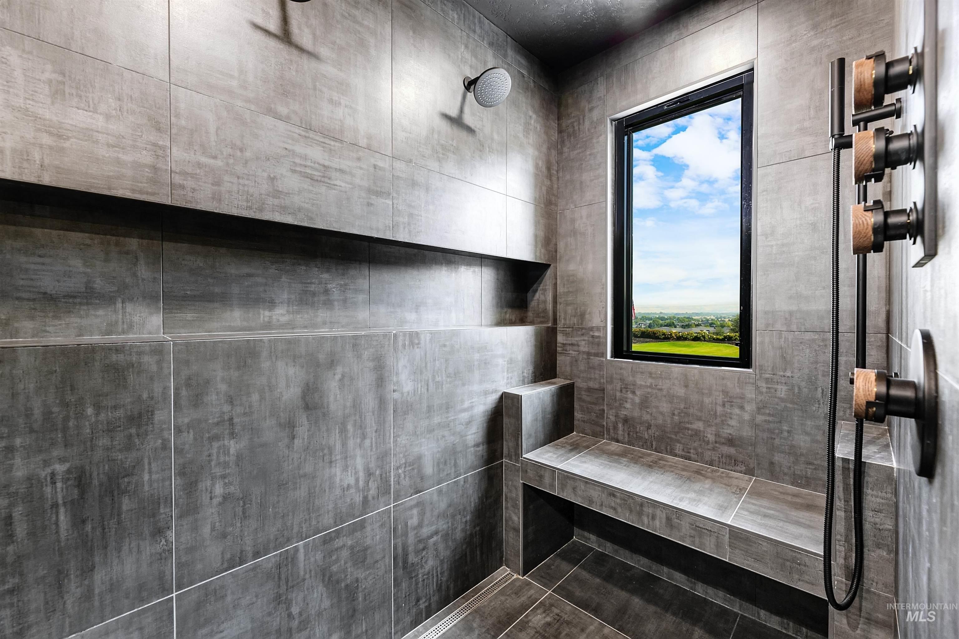 Master bathroom with walk-in tile shower and view.