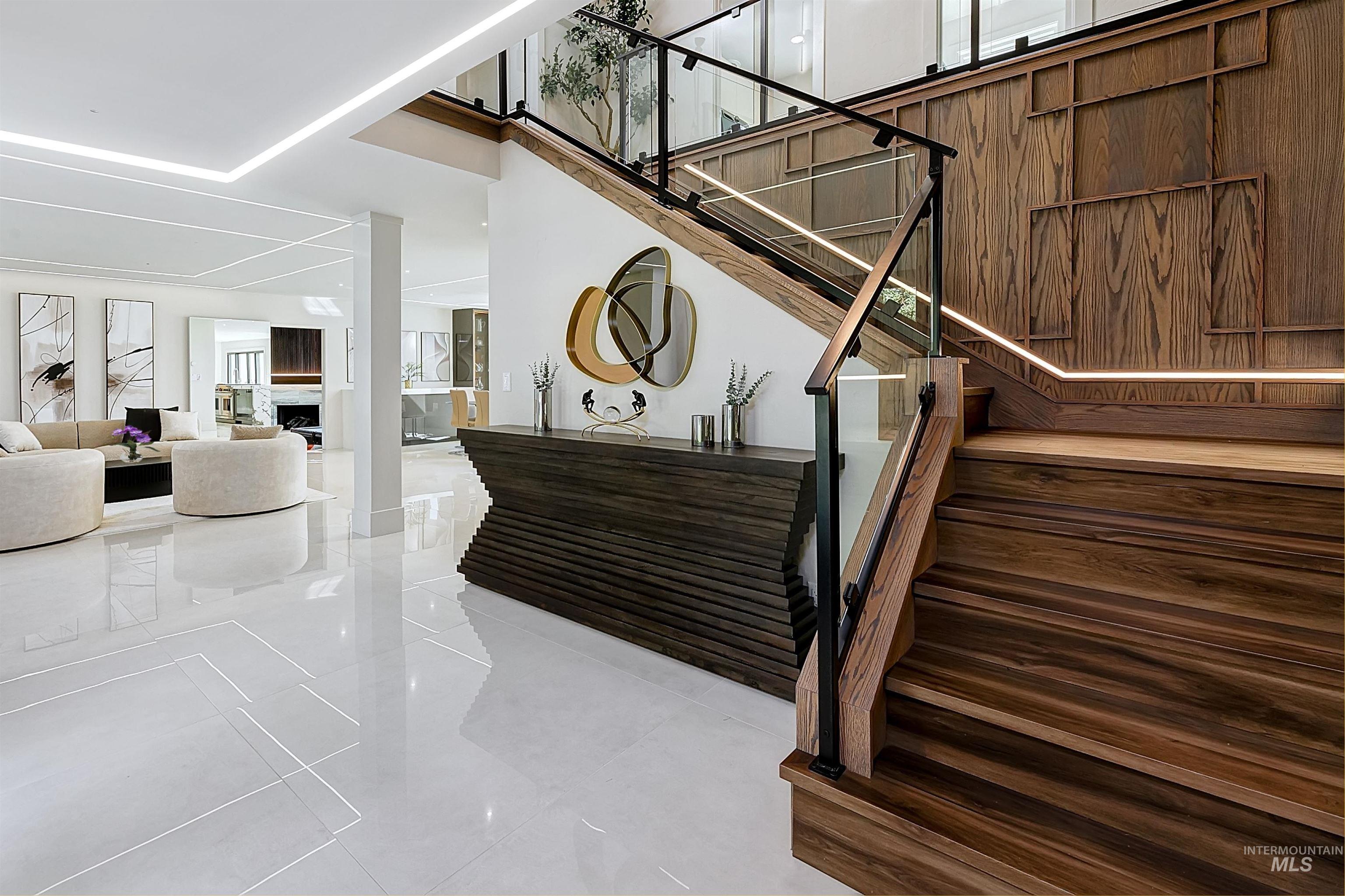 Stairway with tile patterned flooring and a fireplace