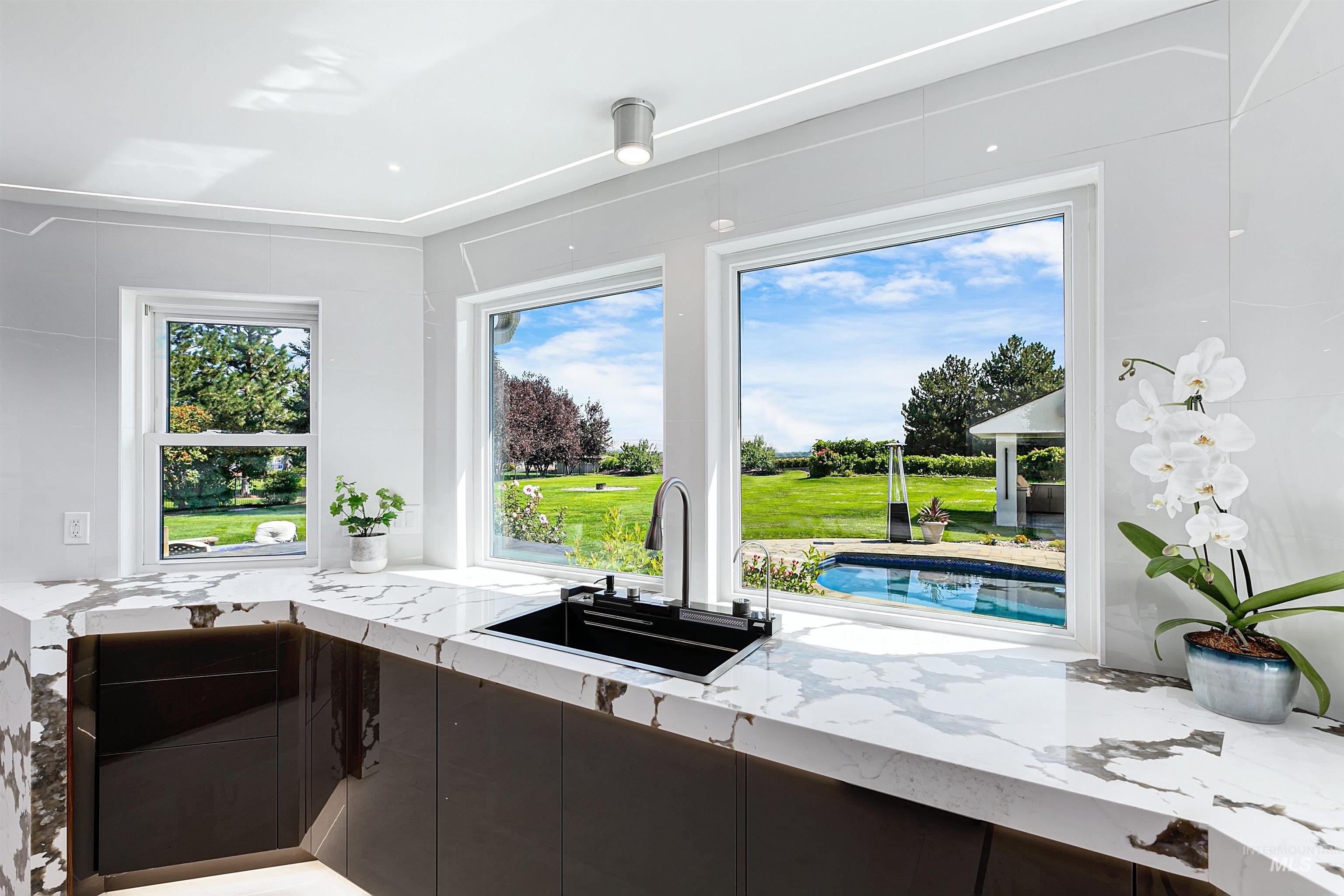 Kitchen featuring quartzite countertops, multi-faceted sink, and modern cabinets.