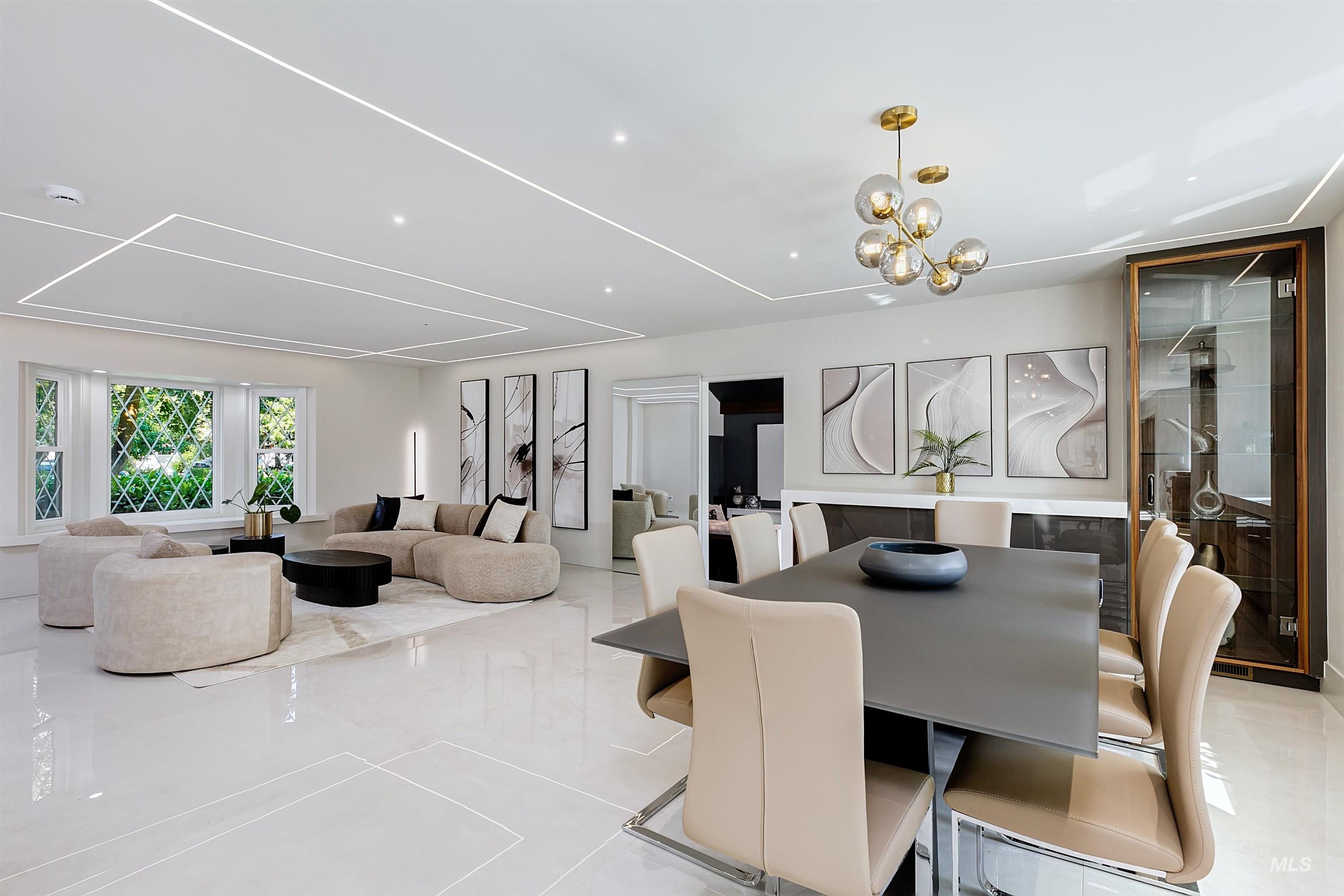 Dining space featuring a chandelier, built-in cabinetry, glass cabinet display, and light tile patterned floors.