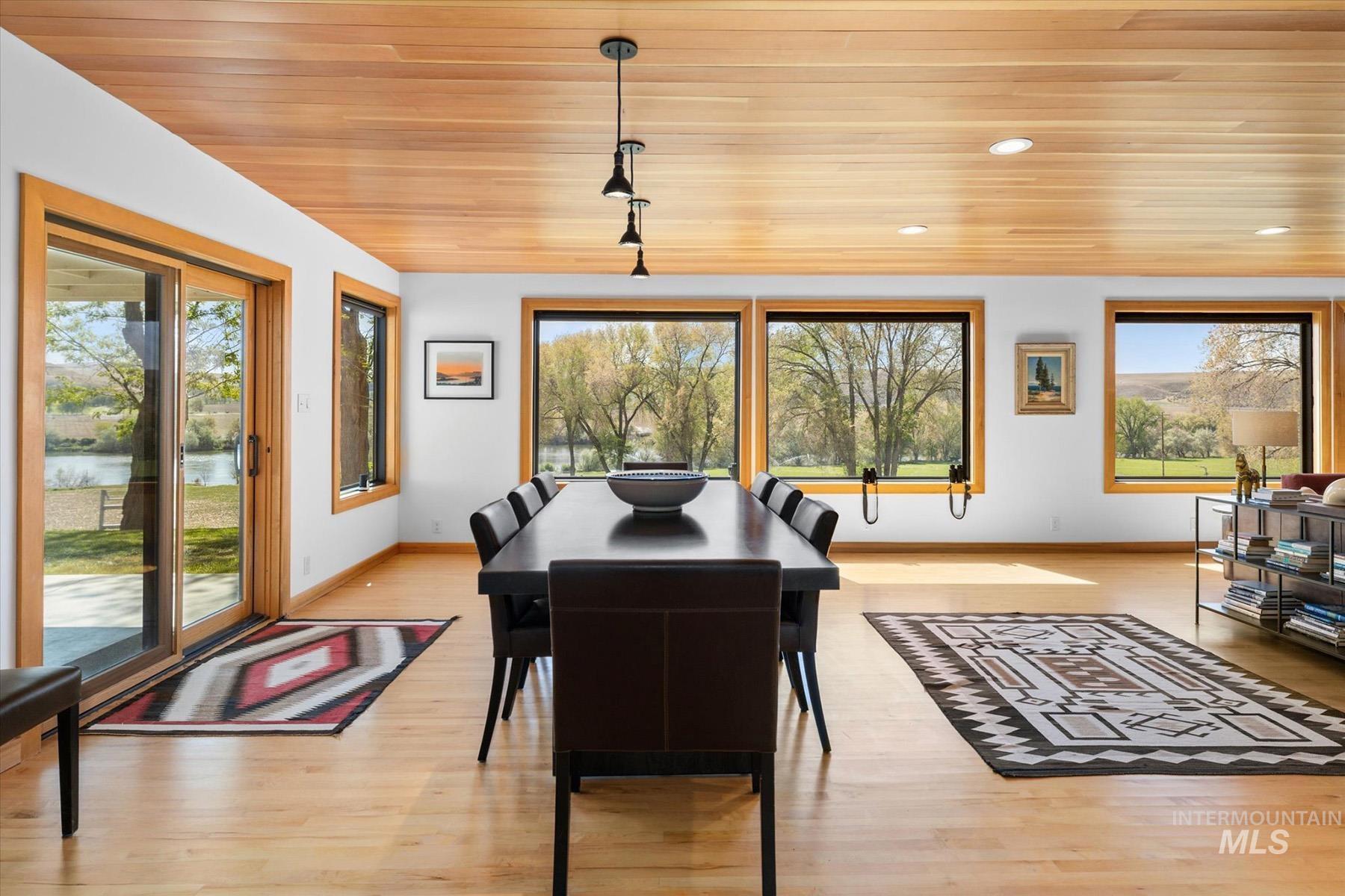 Dining room with wood ceiling, plenty of natural light, light wood finished floors, and recessed lighting