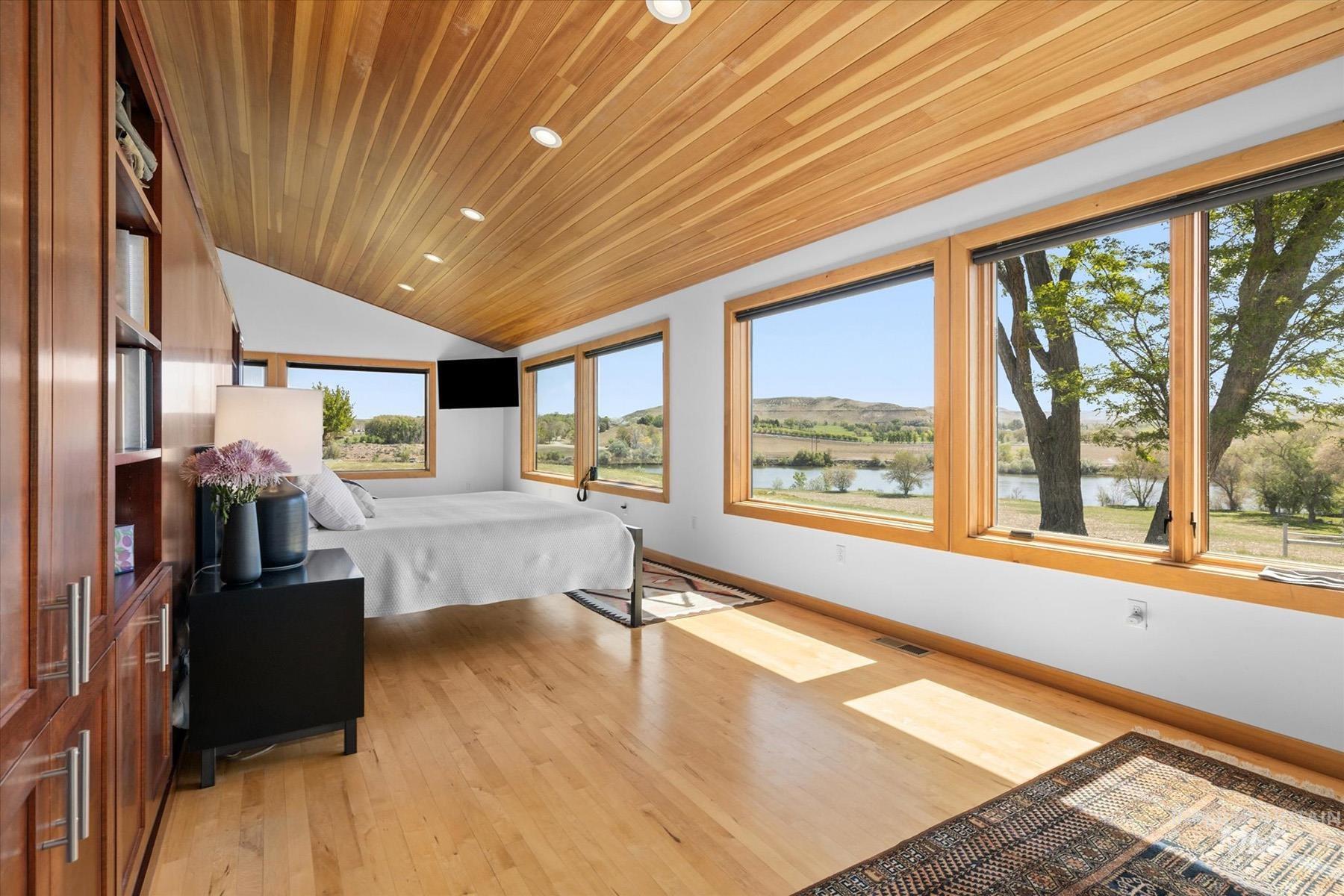 Bedroom featuring light wood finished floors, vaulted ceiling, wood ceiling, and recessed lighting