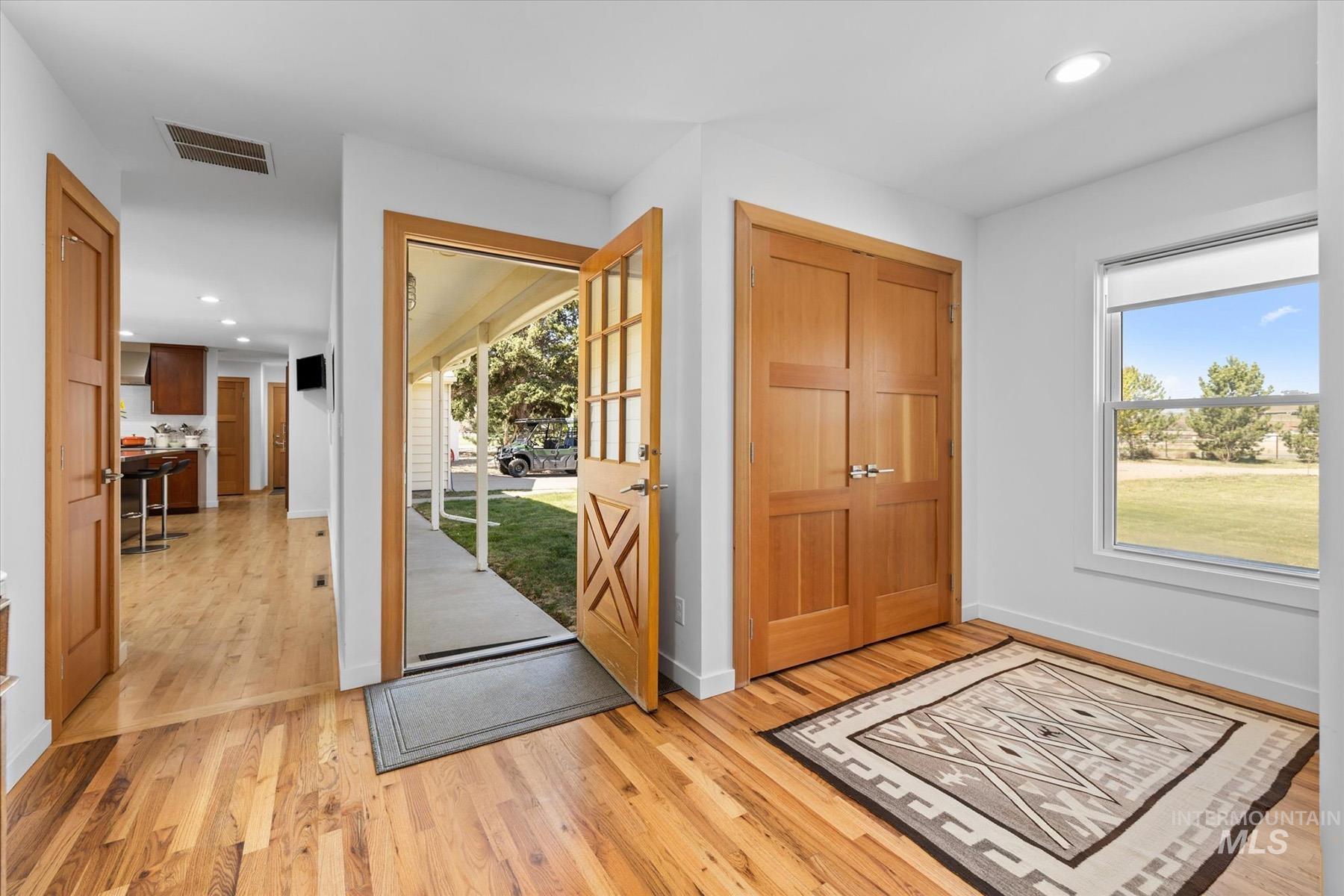 Entryway featuring light wood-type flooring and recessed lighting