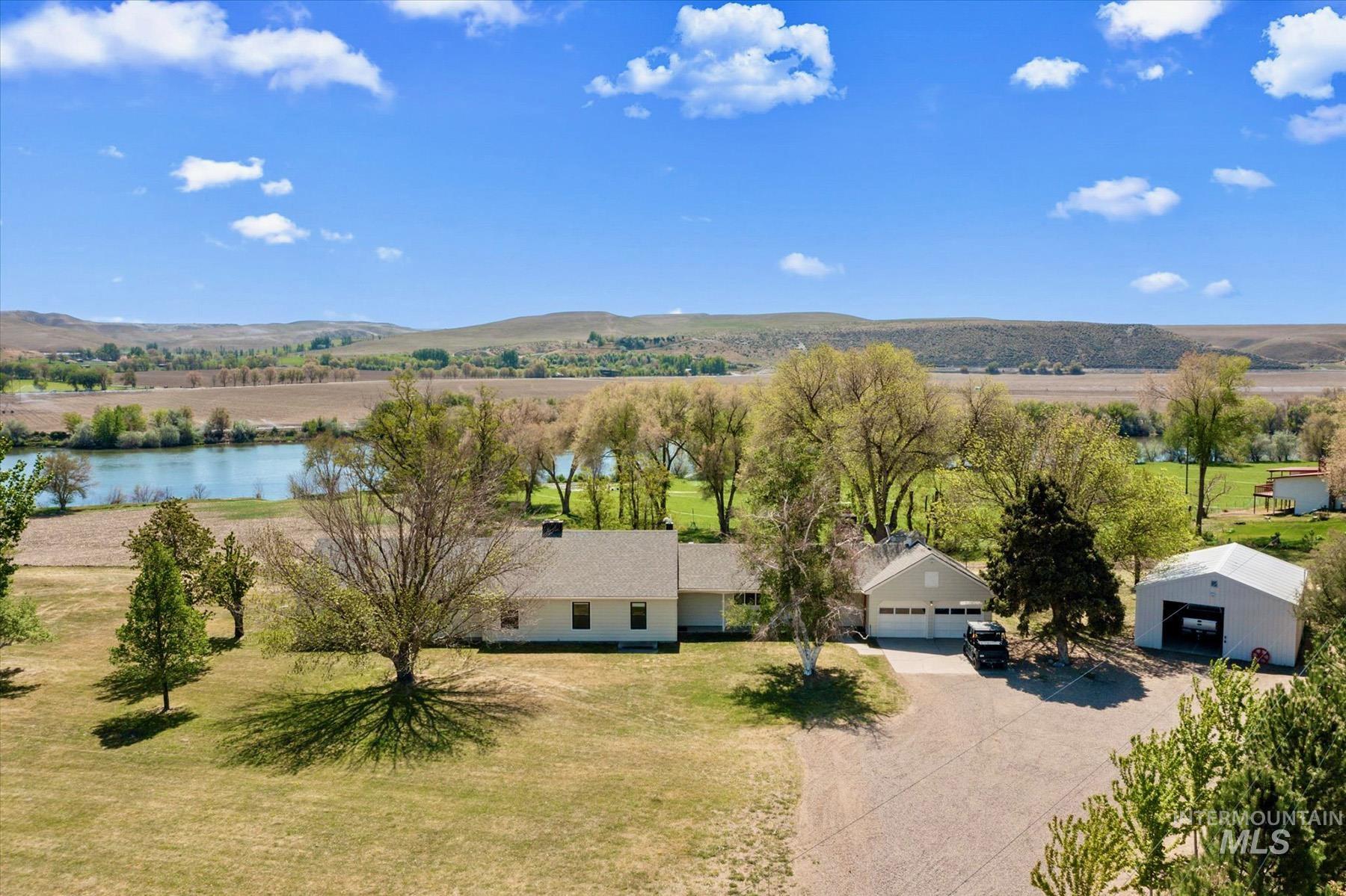 Aerial view of property and surrounding area with a water and mountain view