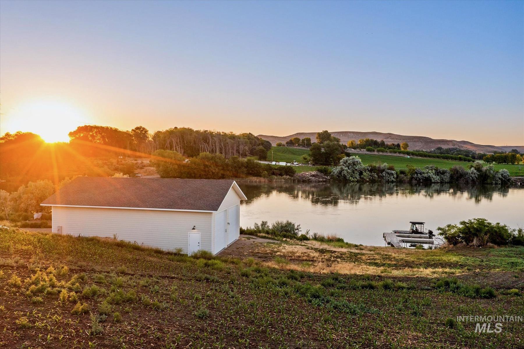 View of home's exterior featuring a water and mountain view, an outdoor structure, and a garage