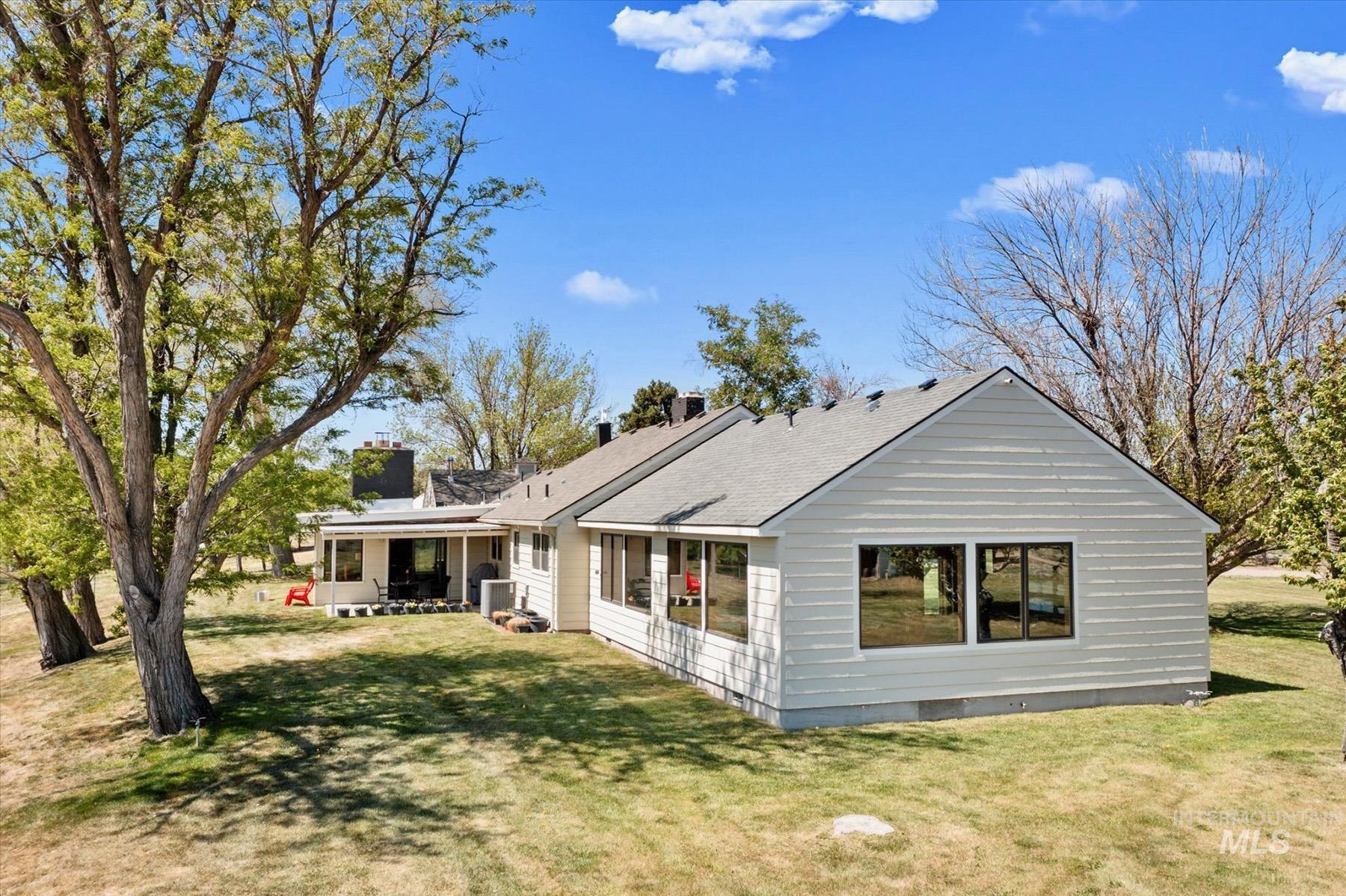 Rear view of house with a yard and a chimney
