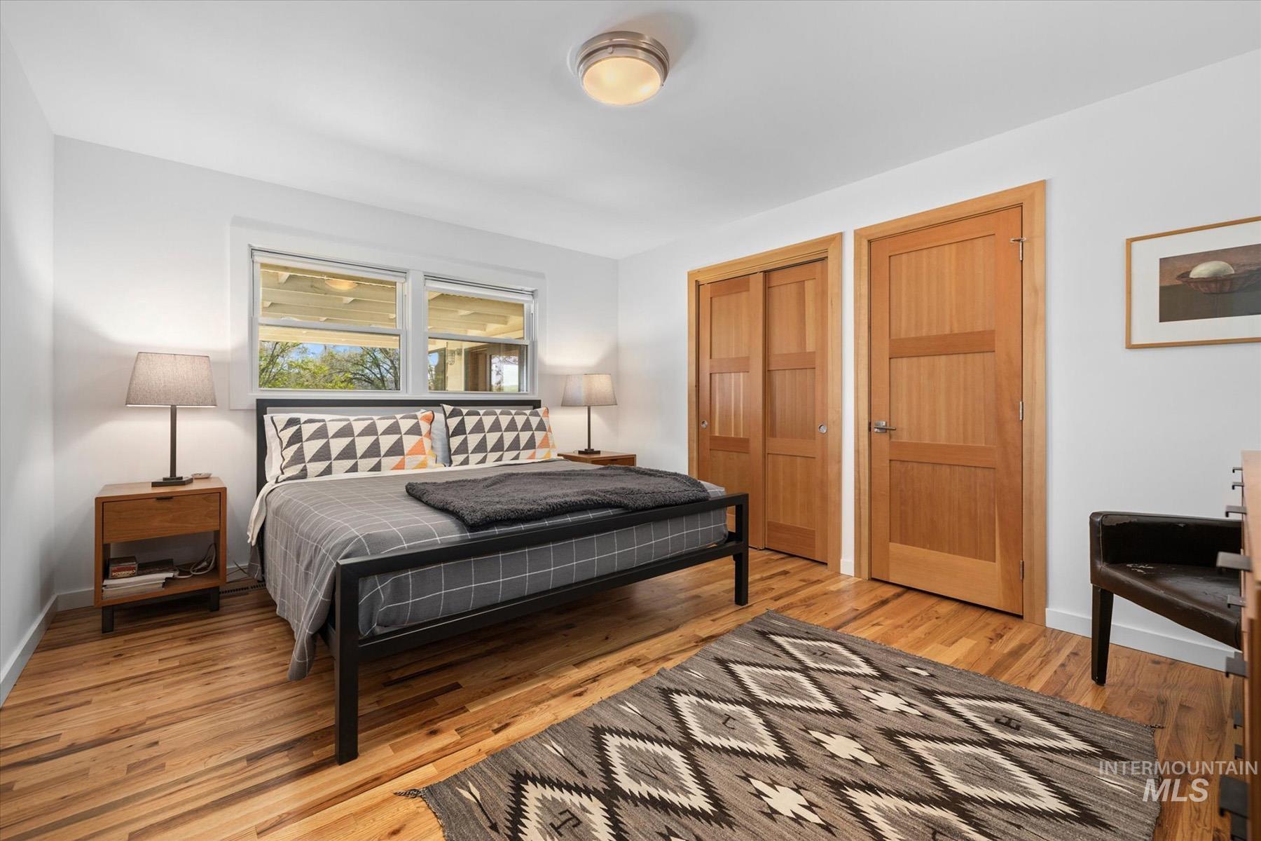 Bedroom featuring light wood-style flooring and baseboards