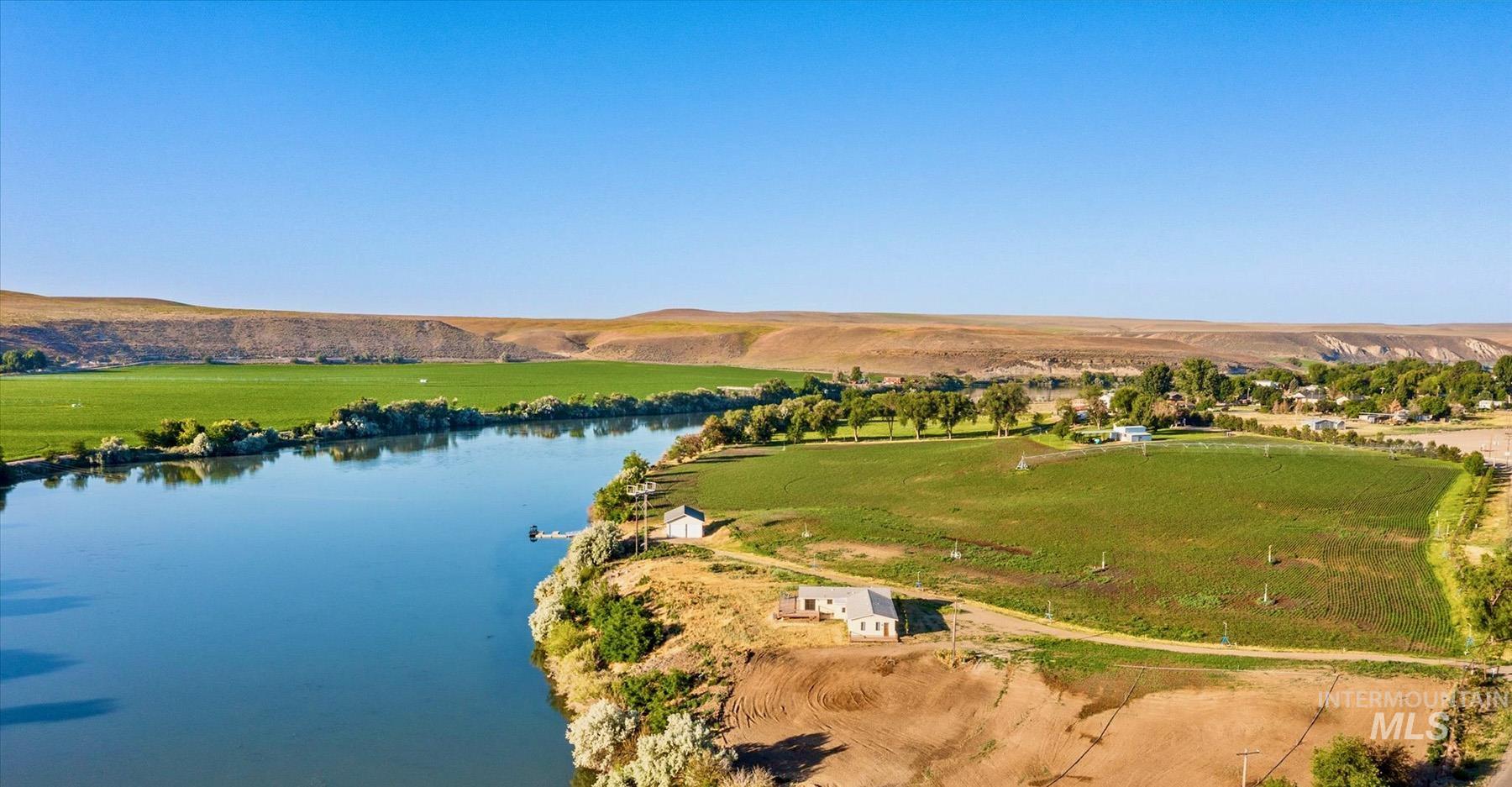 Overview of rural landscape featuring a water and mountain view
