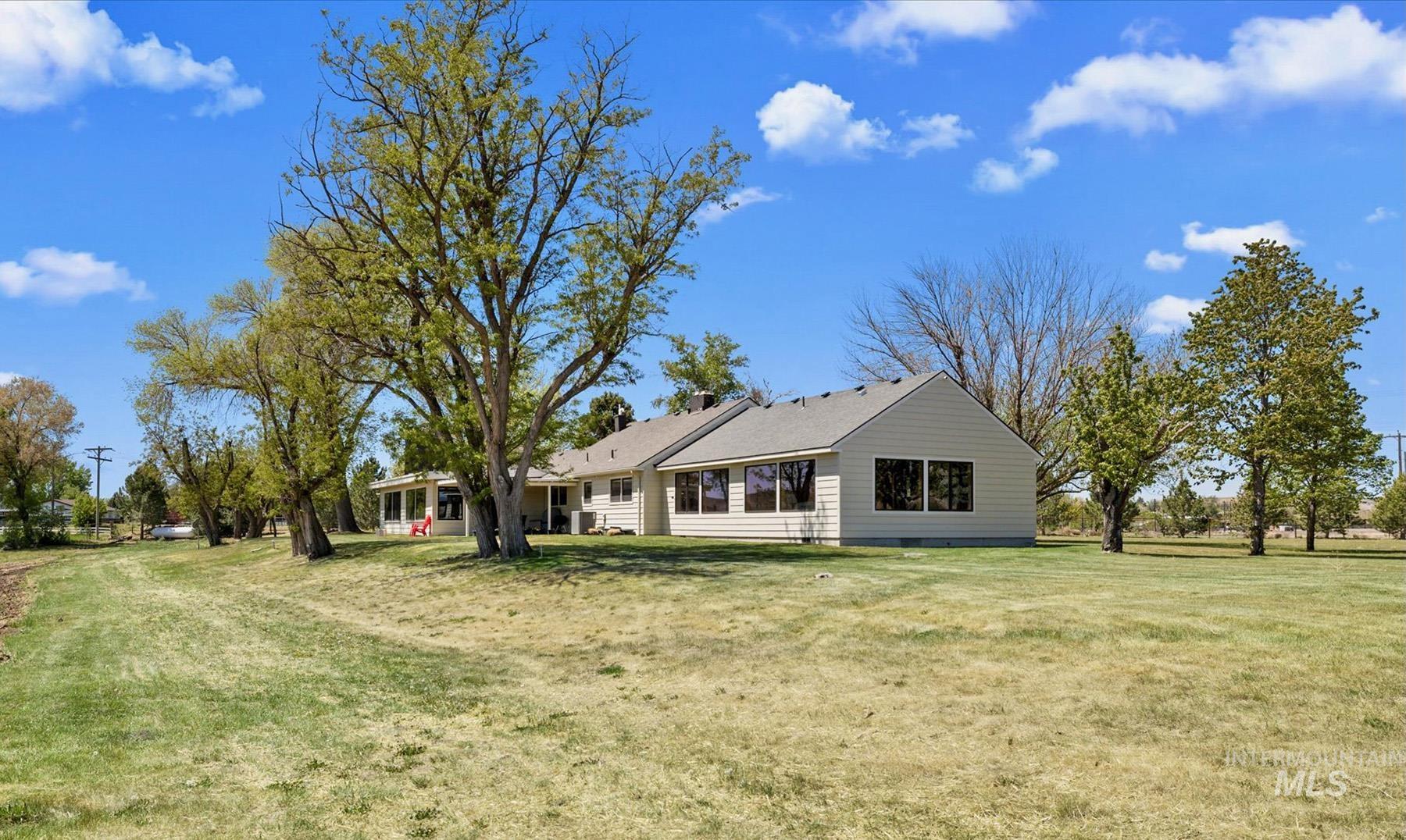 Back of property with a yard