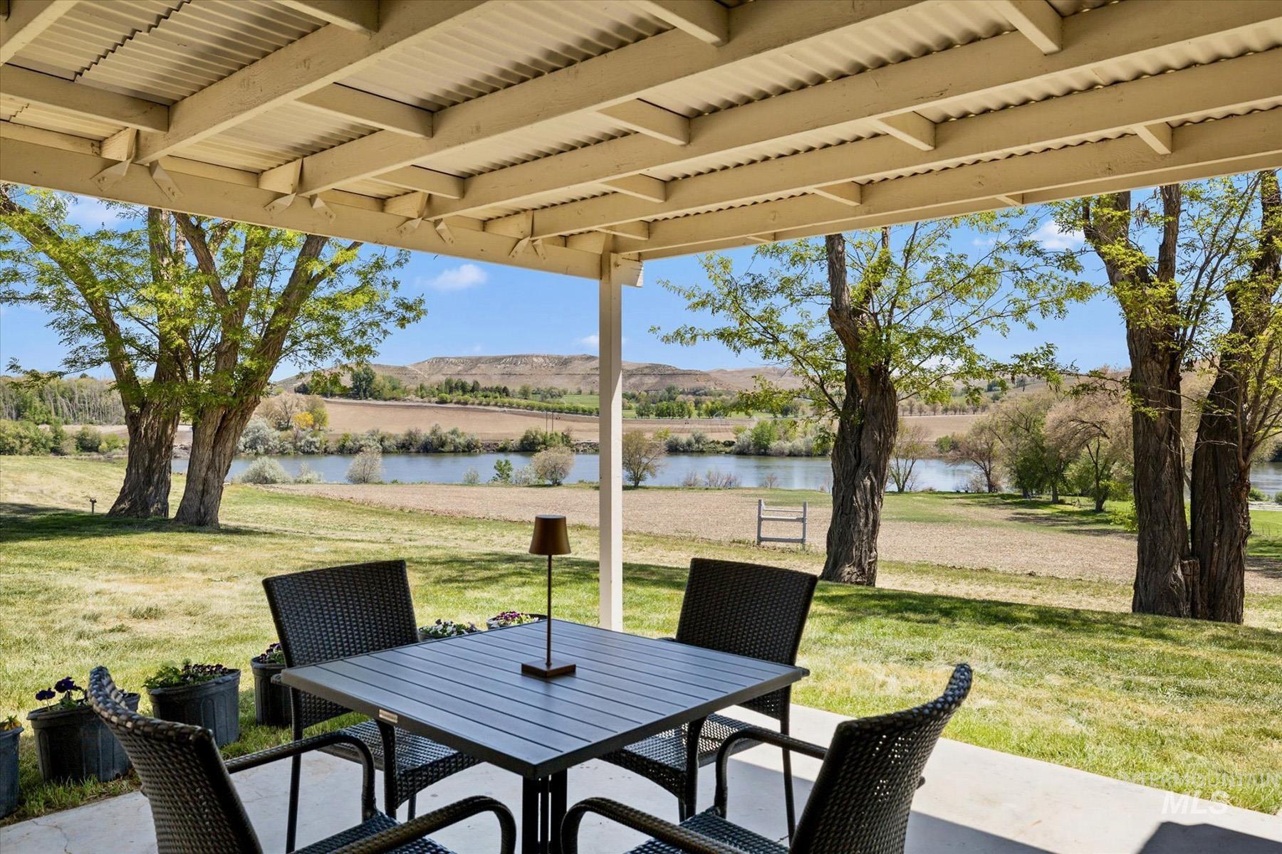 View of patio / terrace with a water view and outdoor dining area