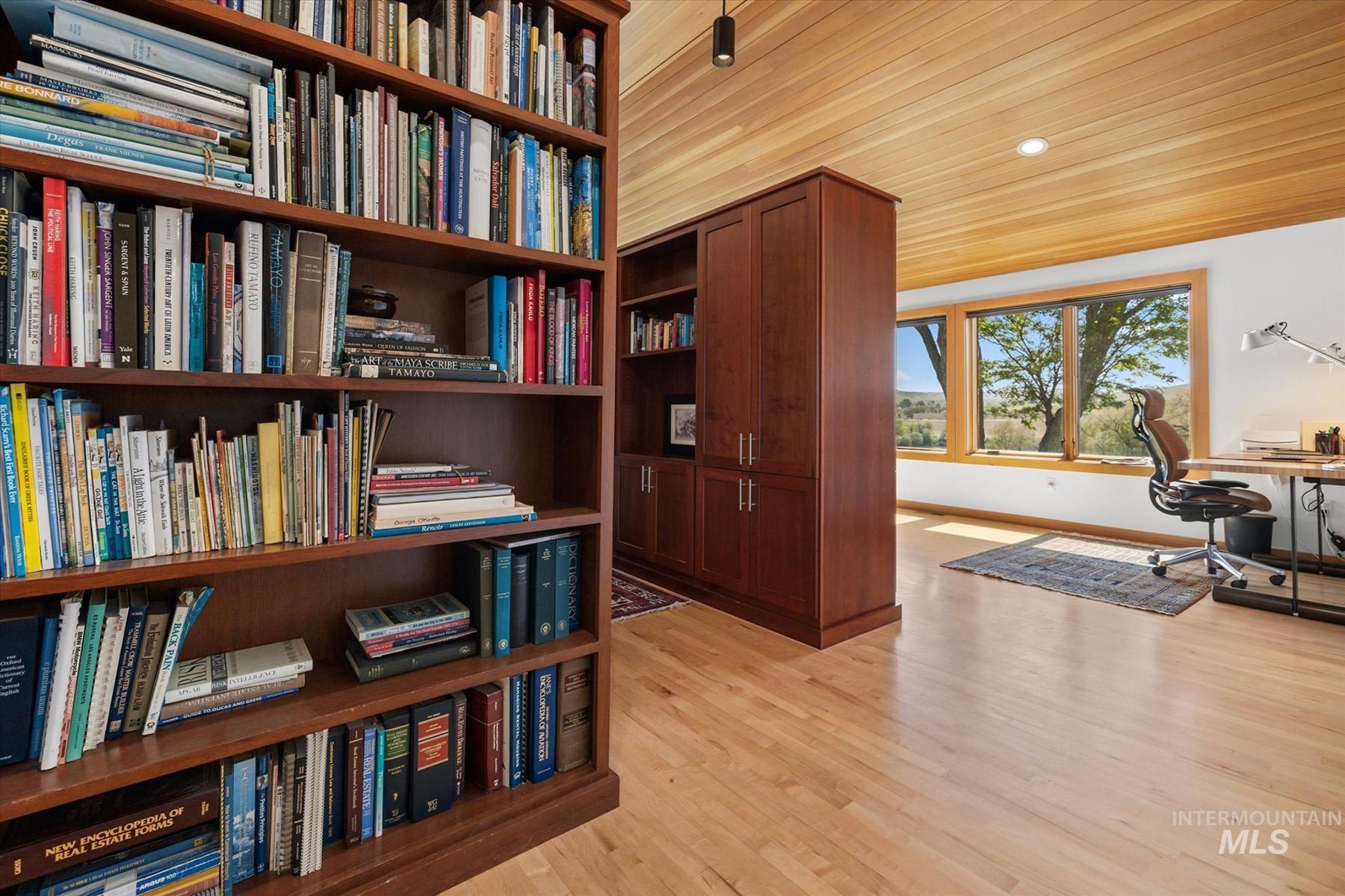Office area featuring wood finished floors and bookshelves