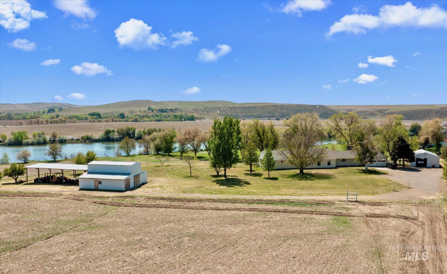 View of mountain background featuring a nearby body of water and rural landscape