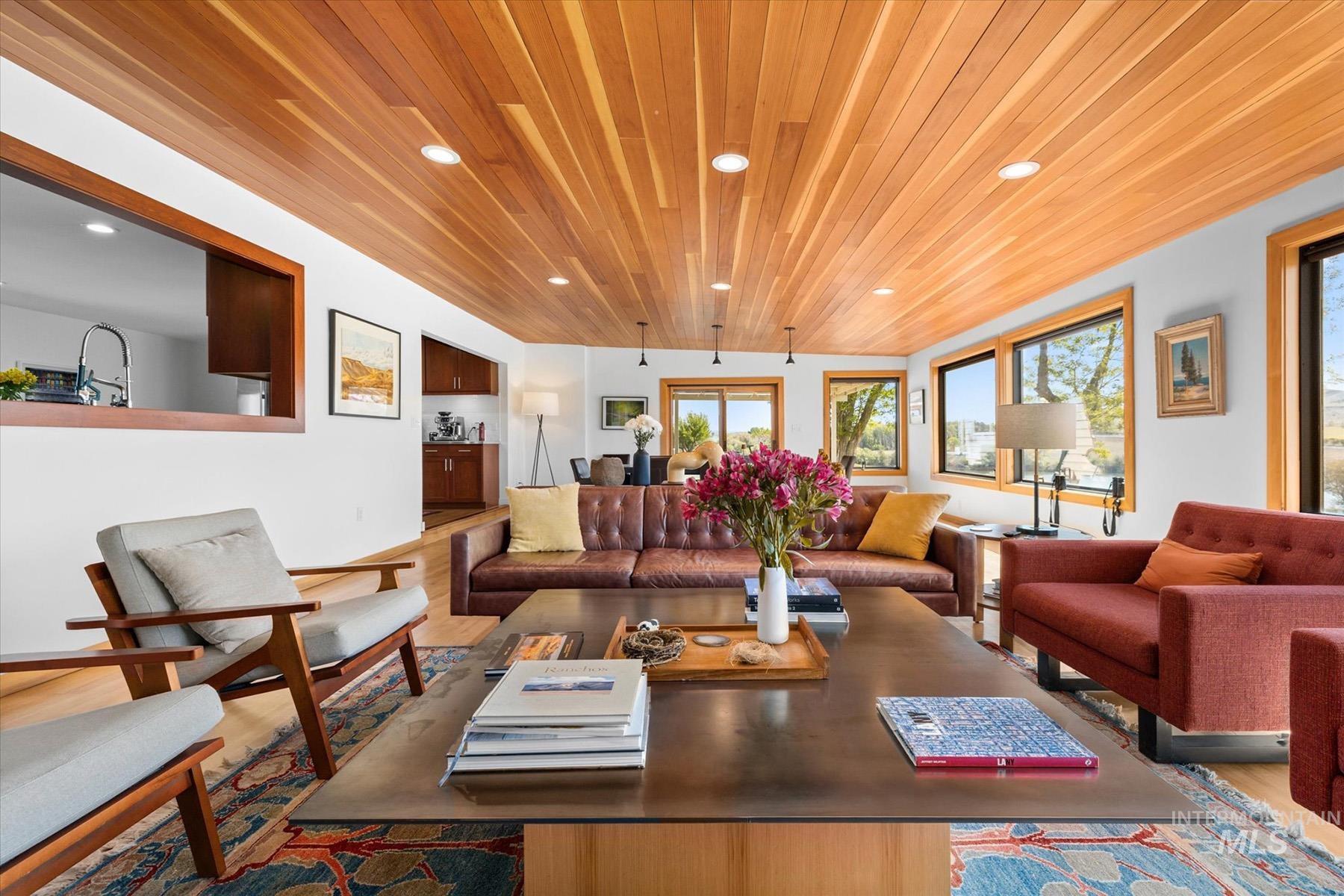 Living room featuring wooden ceiling, recessed lighting, and wood finished floors