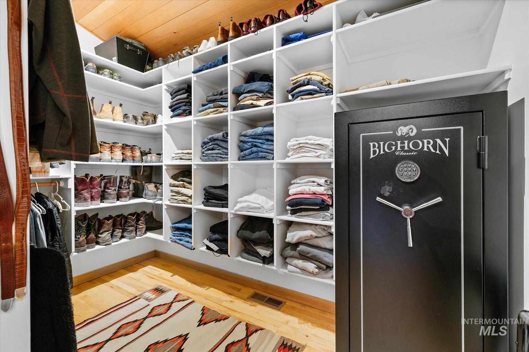 Walk in closet featuring wood finished floors