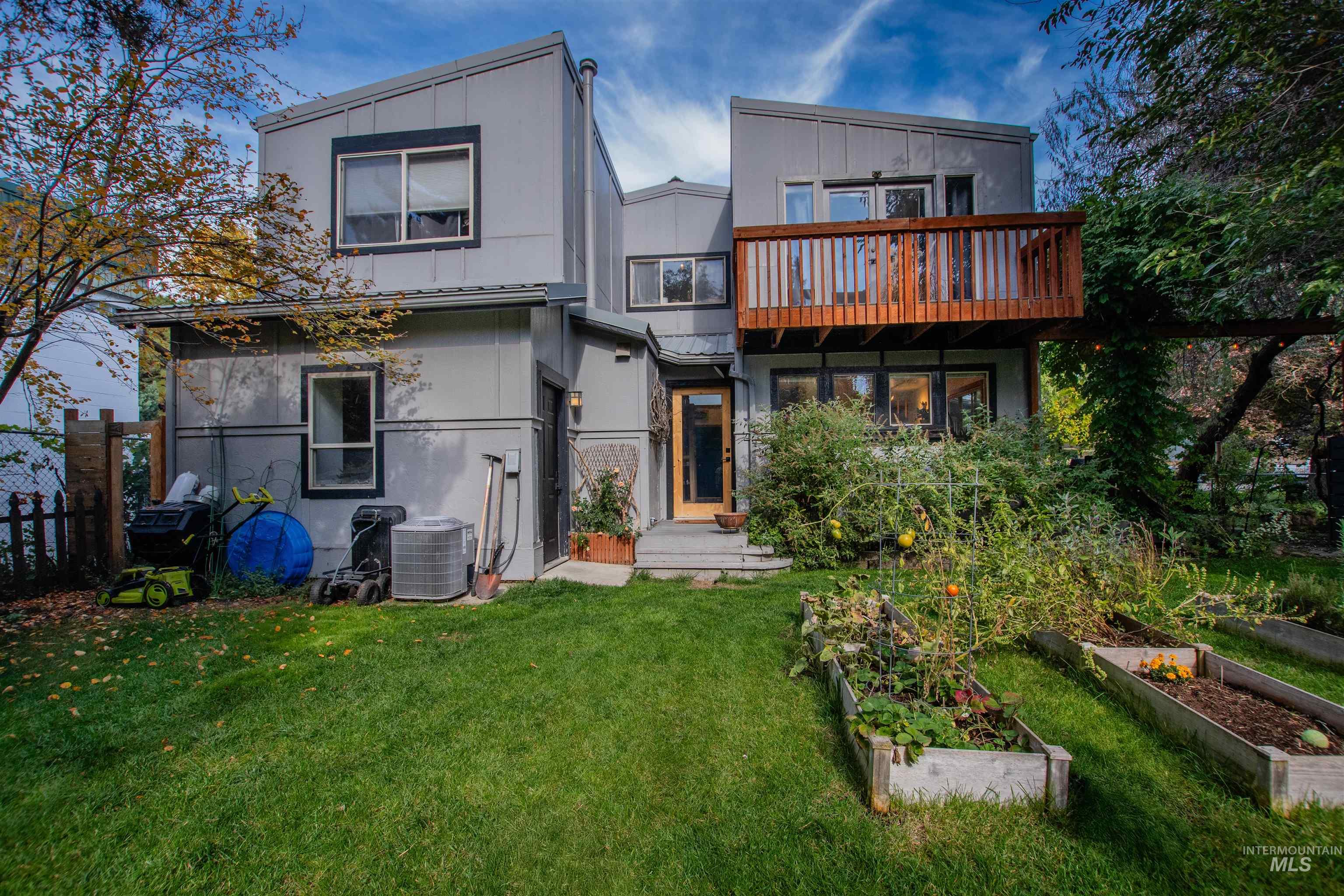 Back of property with a garden and a metal roof