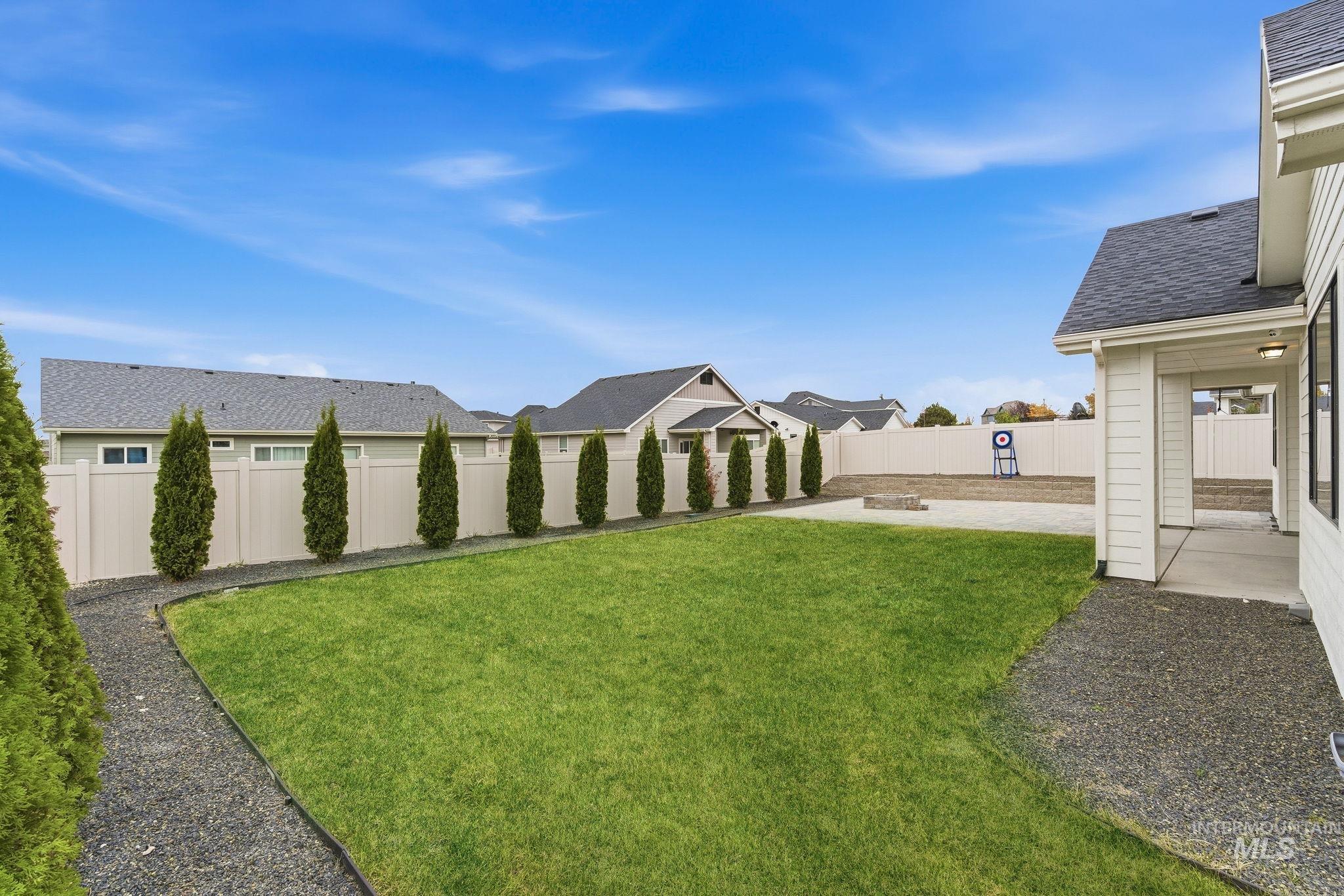 Fenced backyard featuring a residential view