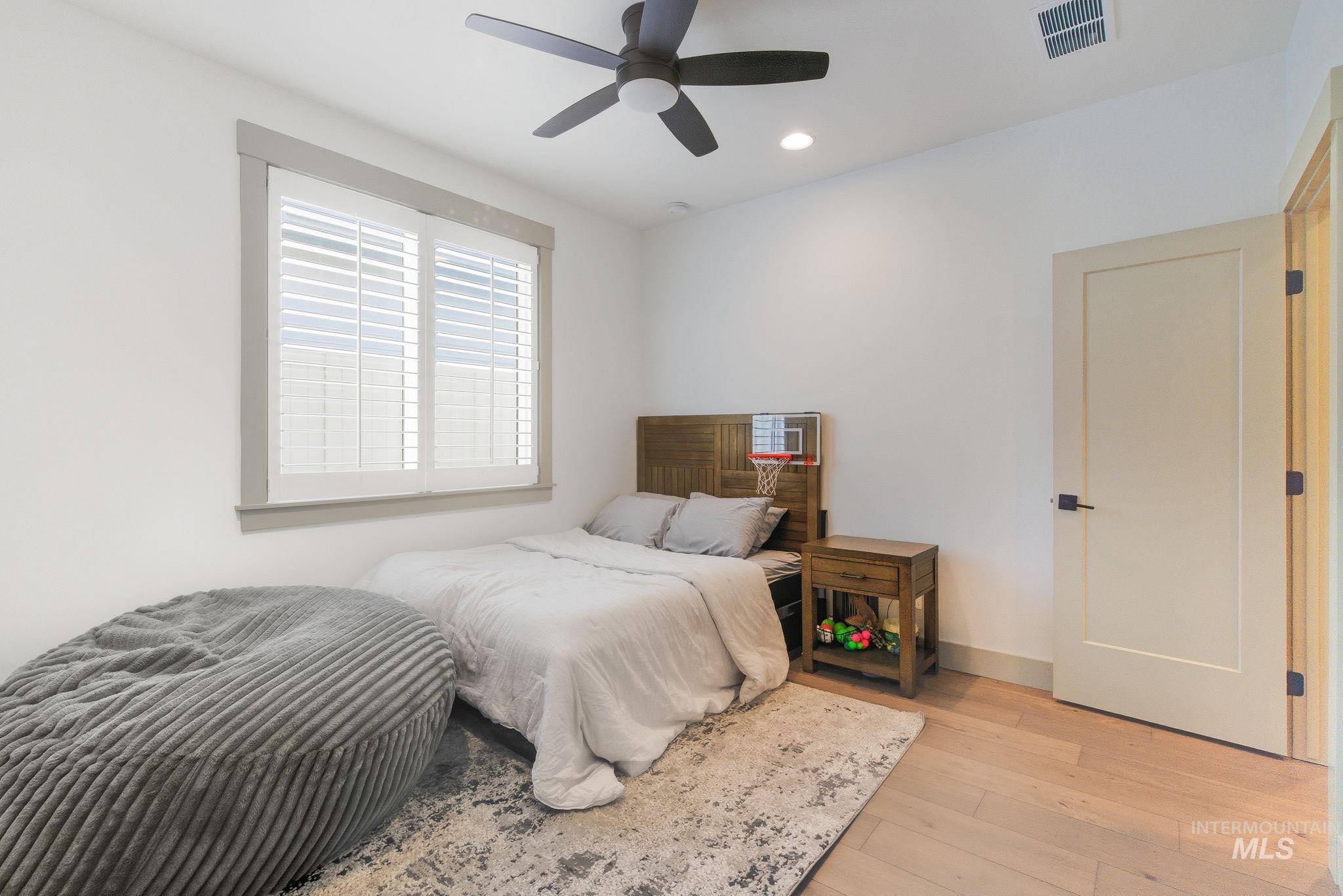 Bedroom featuring light wood-style floors, recessed lighting, and ceiling fan