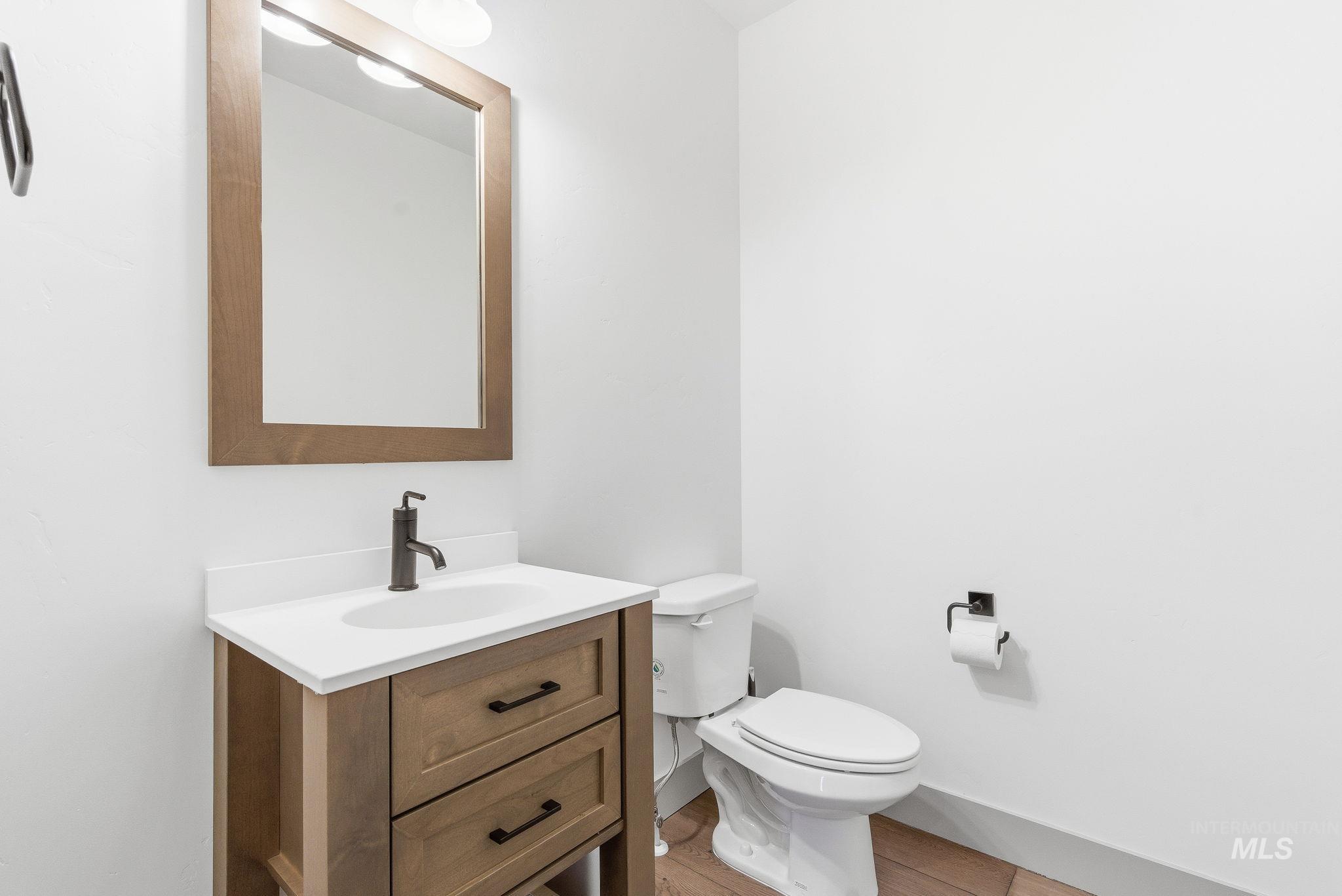Half bath featuring vanity and light wood-style floors