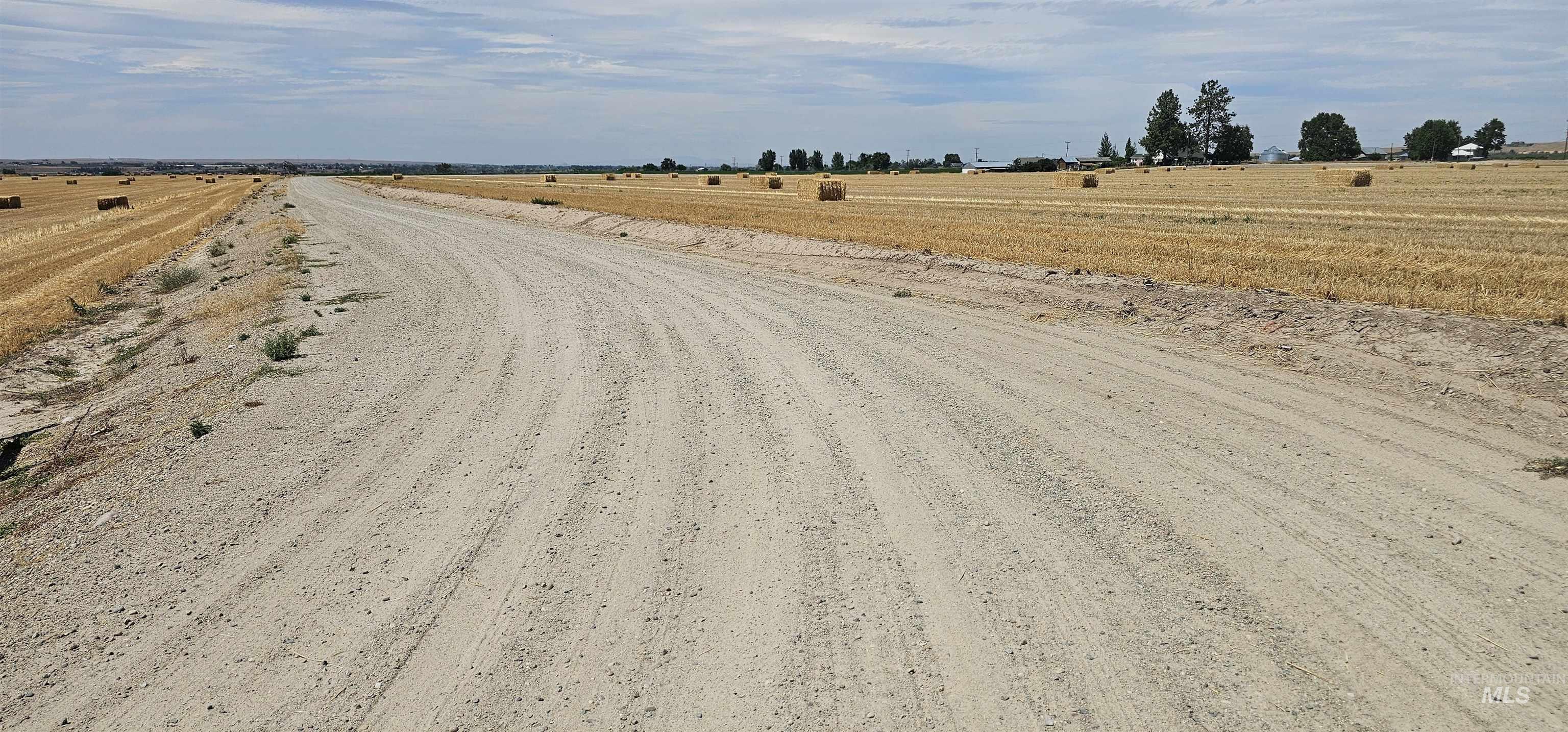 View of dirt / gravel road with a view of countryside