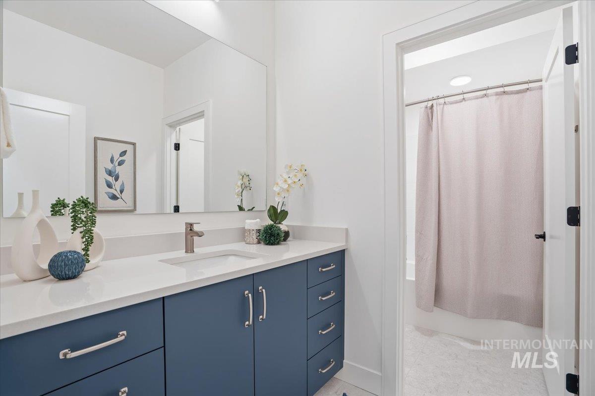Bathroom with vanity and shower / bathtub combination with curtain