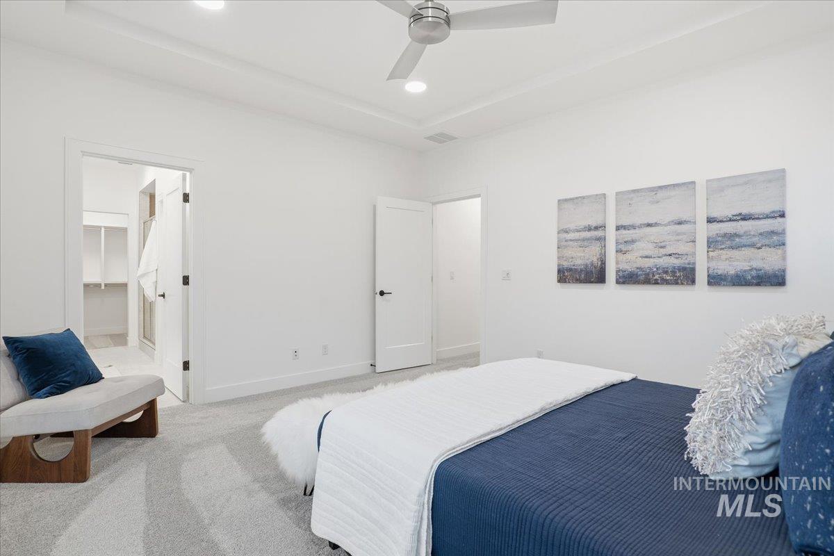 Bedroom with ceiling fan, carpet flooring, a walk in closet, and recessed lighting