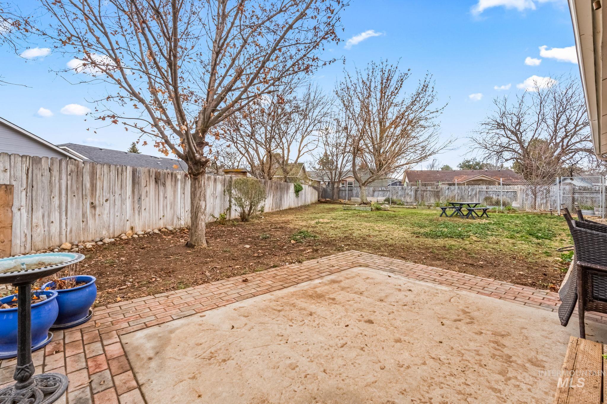 Fenced backyard with a patio