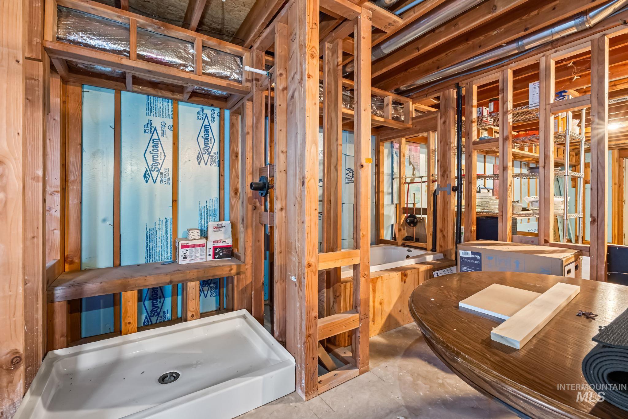 Full bath with a tub and unfinished concrete flooring