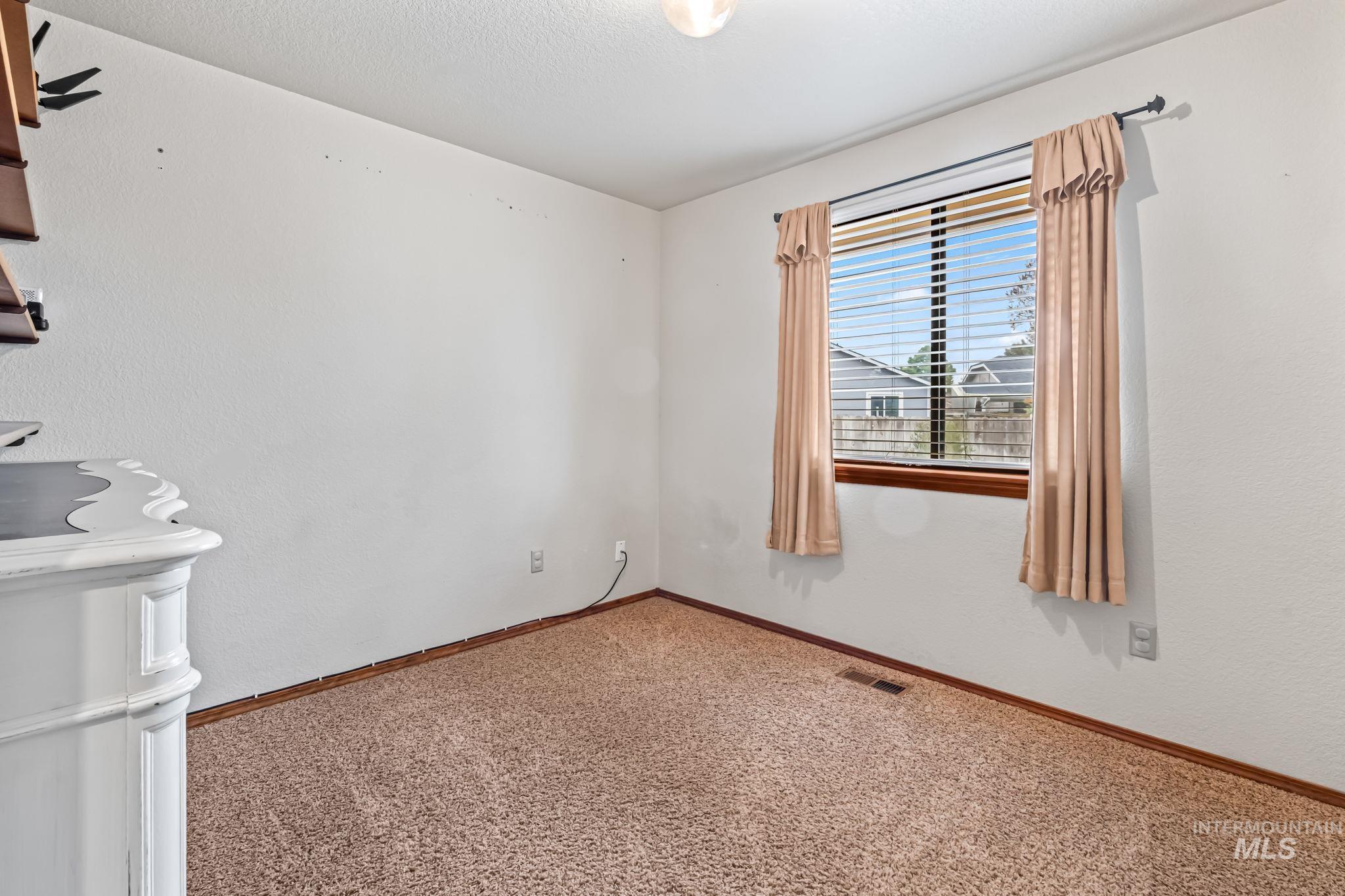 Unfurnished room featuring carpet floors and baseboards