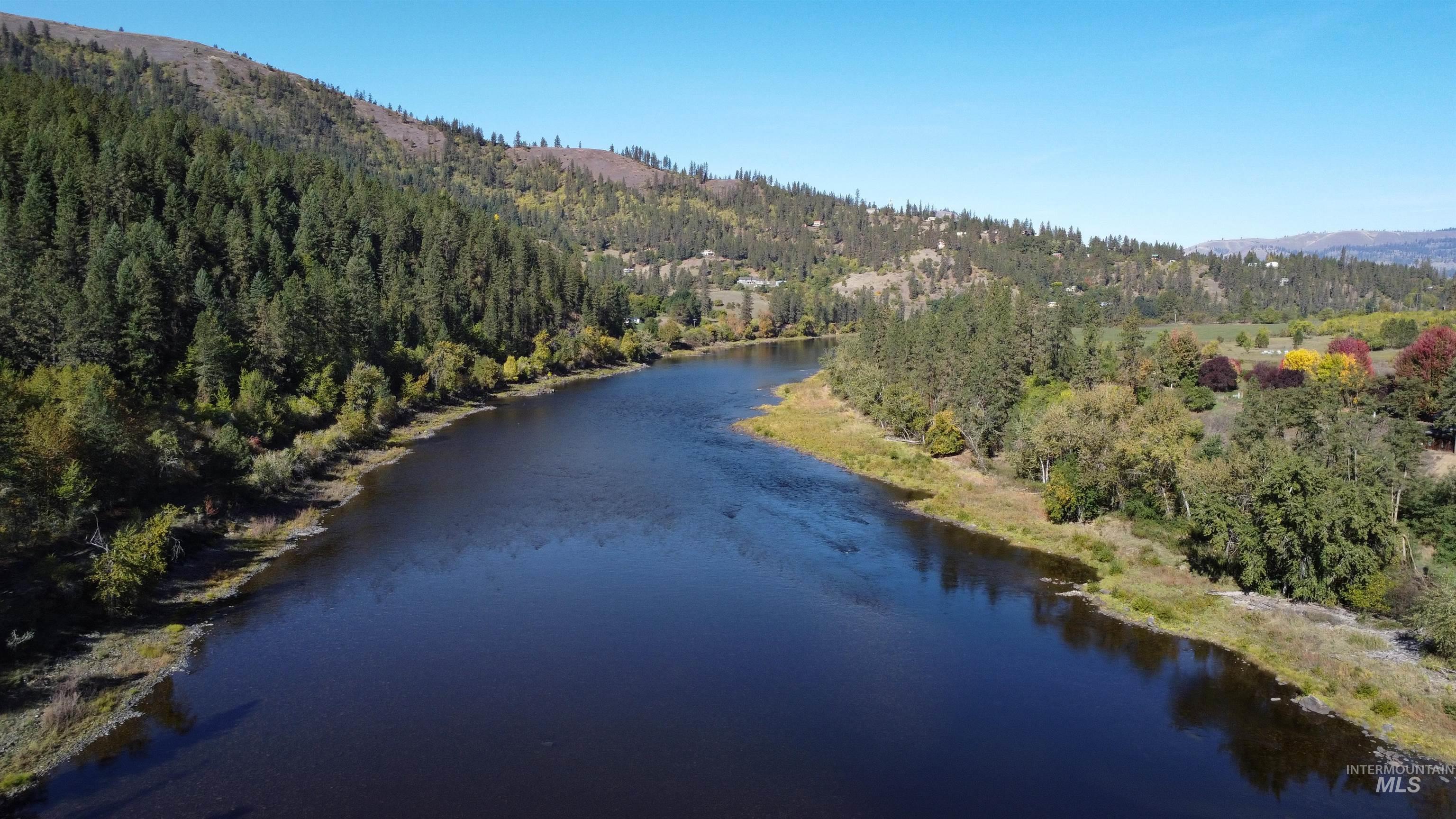 Aerial view of a nearby body of water and a forest
