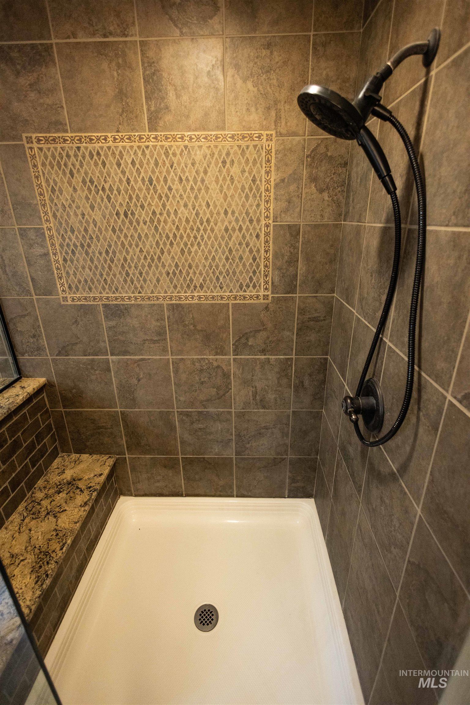 Full bath with a tile shower