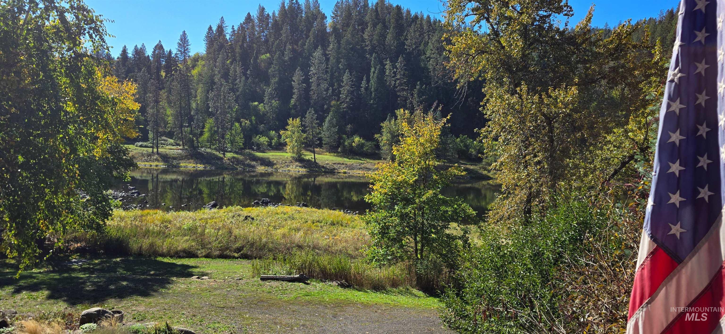 Exterior space with a wooded view and a water view
