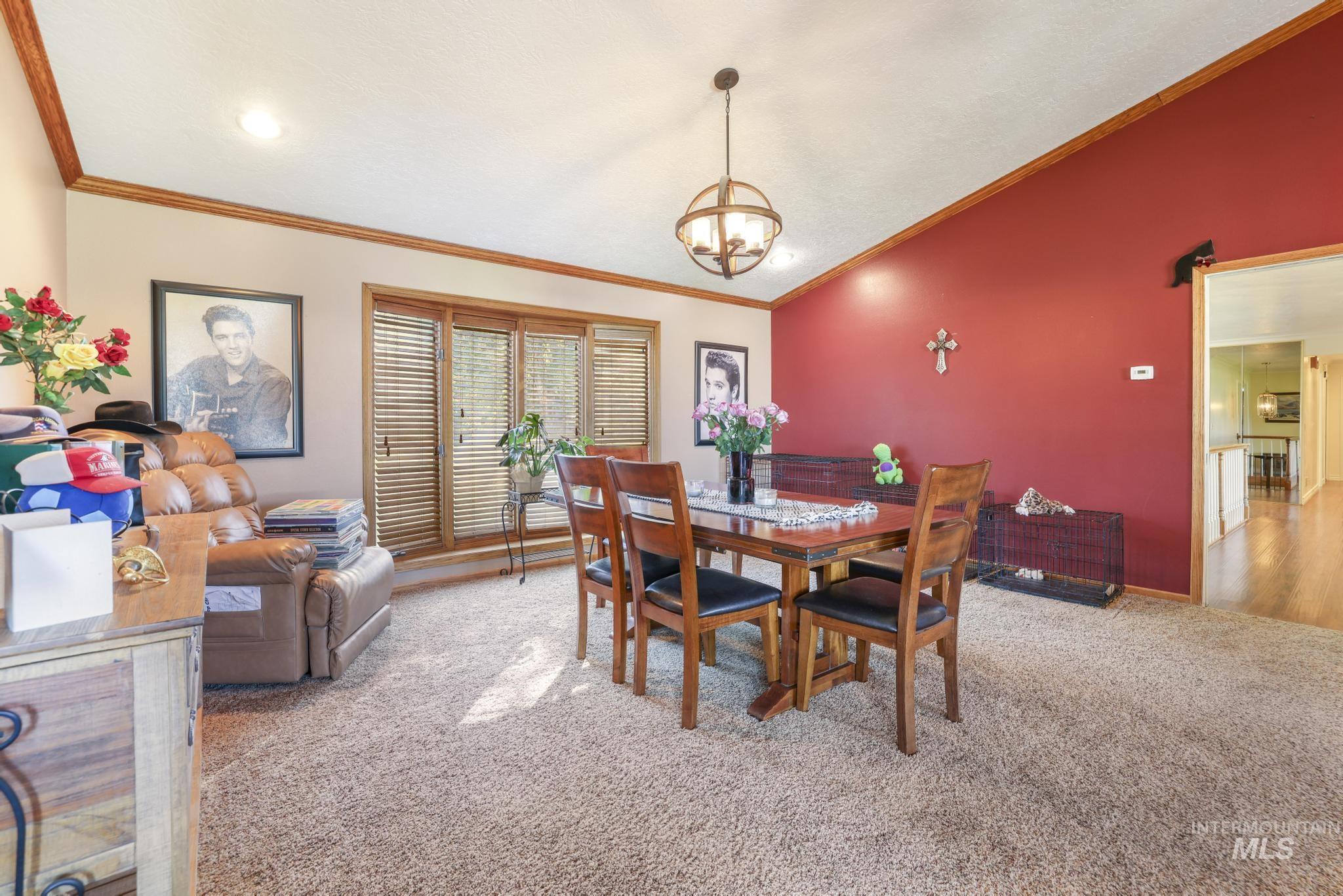 Dining room with light colored carpet and crown molding
