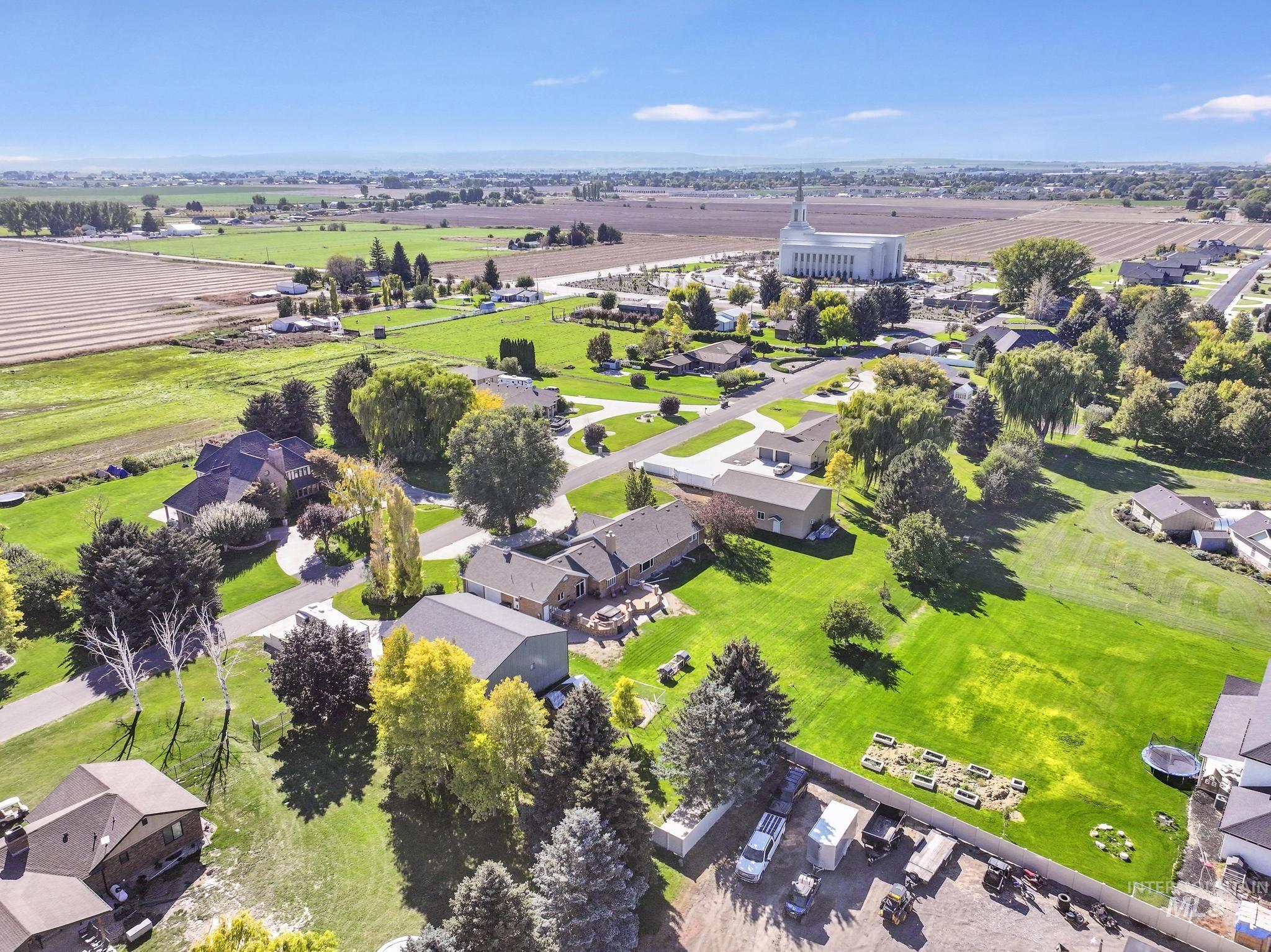 Aerial view of residential area with rows of crops