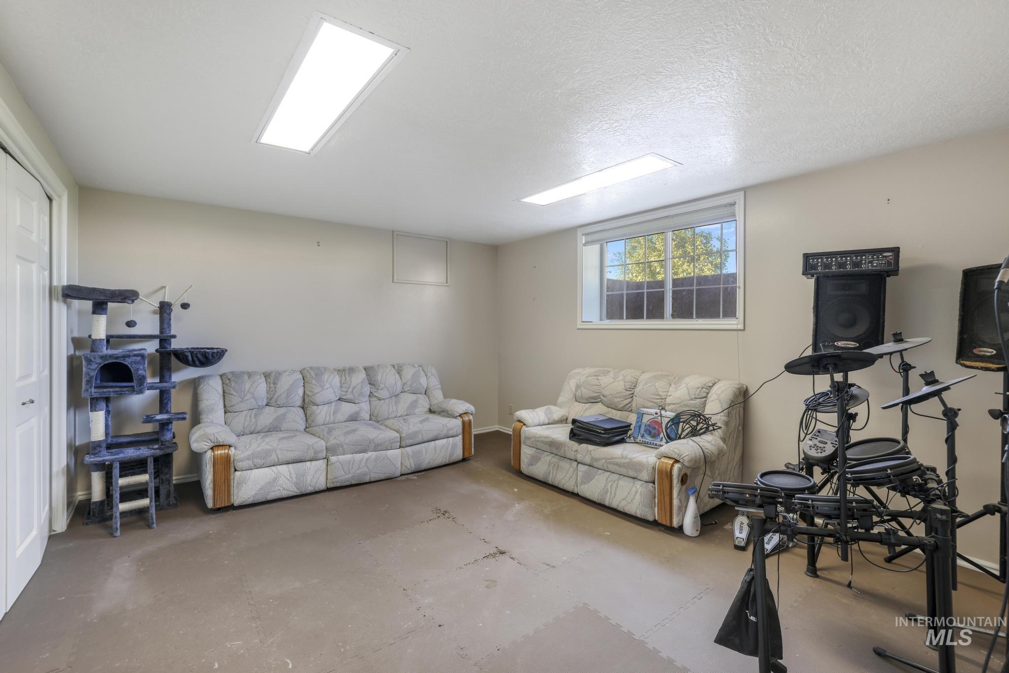 Living room with concrete flooring and a textured ceiling