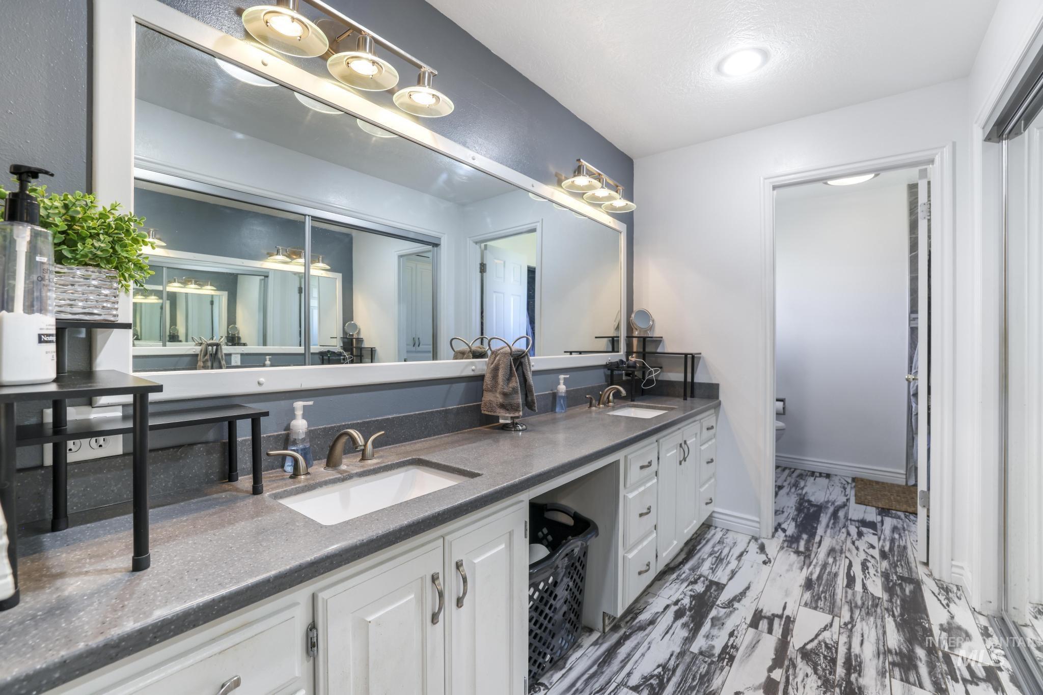Bathroom featuring double vanity and toilet