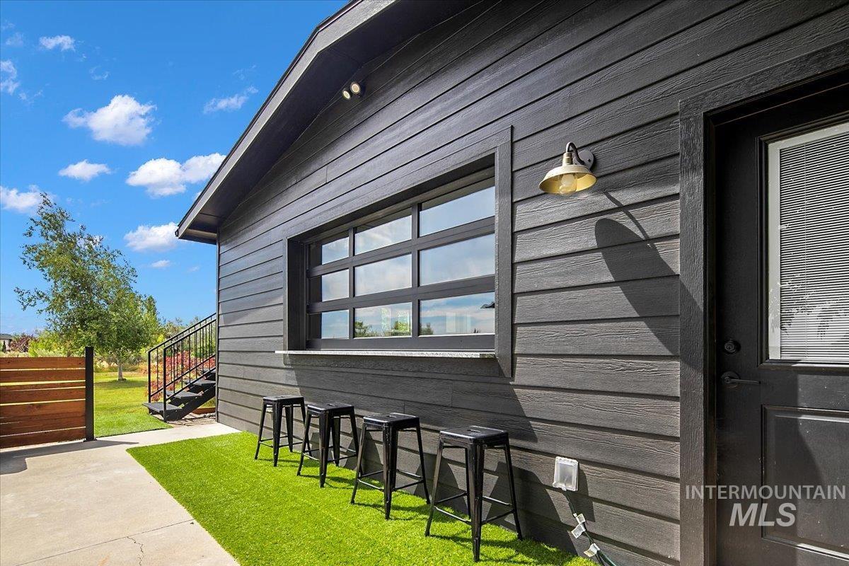 View of property exterior with a yard and a patio area off of the pool room.