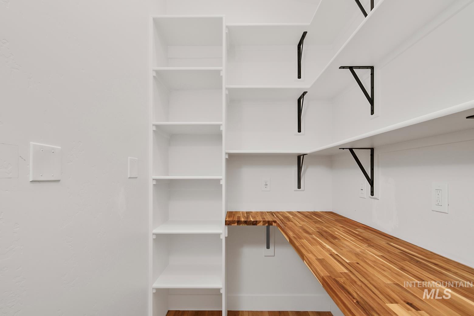 View of walk in pantry with butcher block shelving