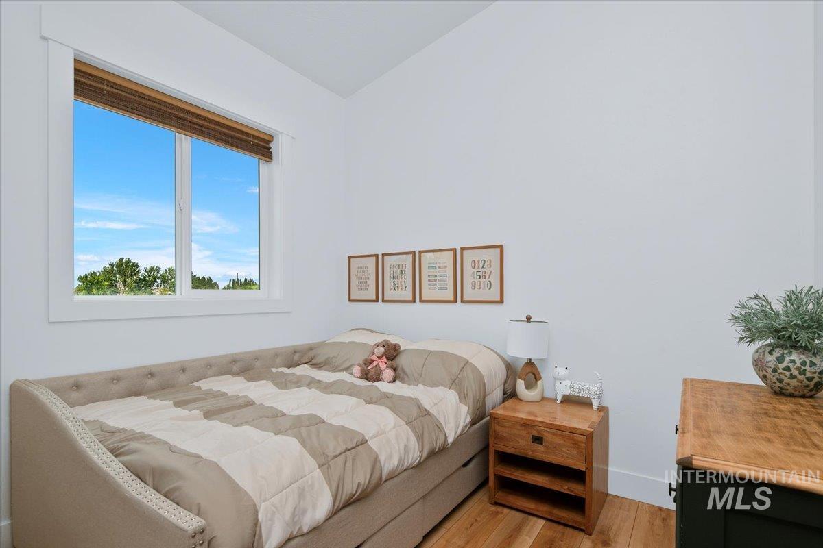 Bedroom or Office featuring light LVIP floors, ductless heating/cooling.