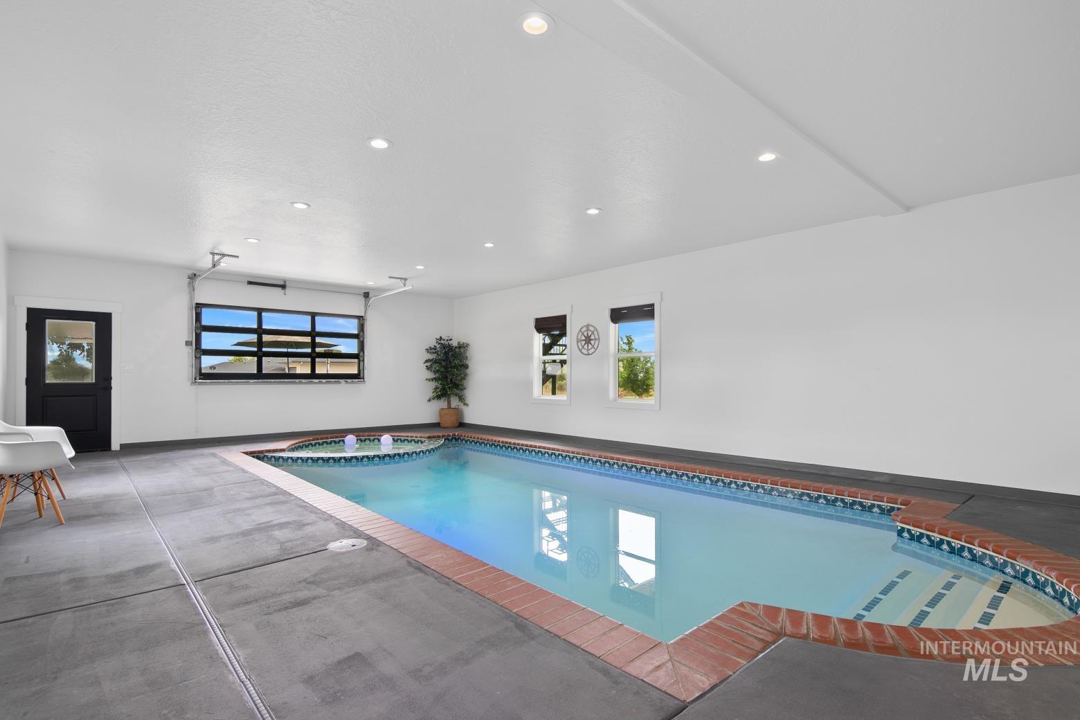 View of swimming pool with a pool with connected hot tub