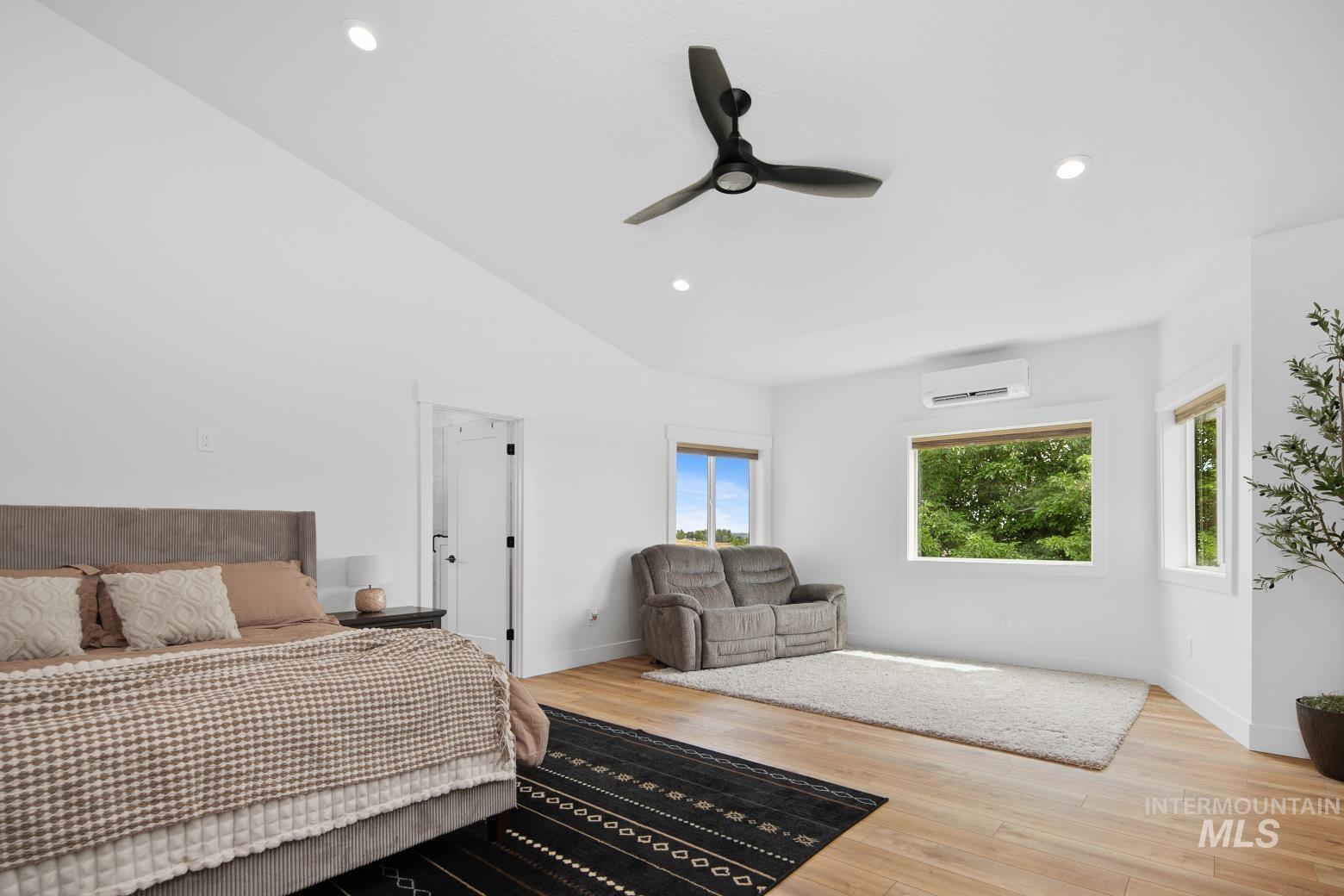 Bedroom featuring wood finished floors, recessed lighting, ceiling fan, and vaulted ceiling