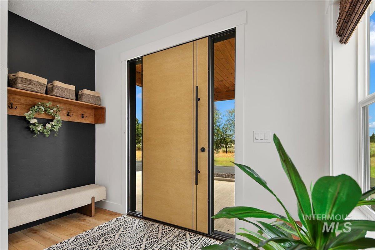 Doorway featuring light wood-type flooring and plenty of natural light