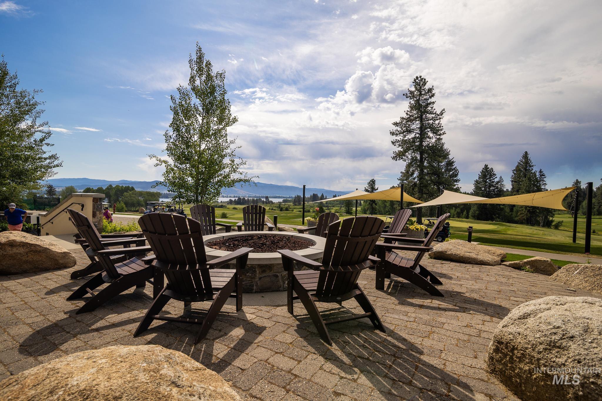 View of patio / terrace featuring an outdoor fire pit and a mountain view