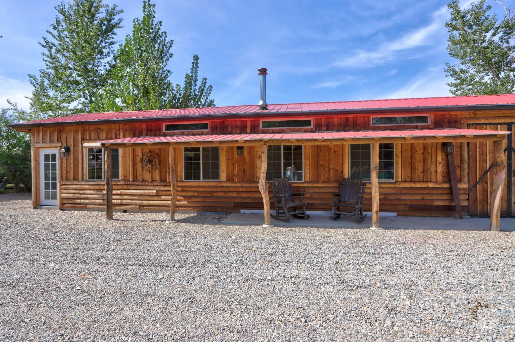 View of front of home with board and batten siding, crawl space, and a metal roof