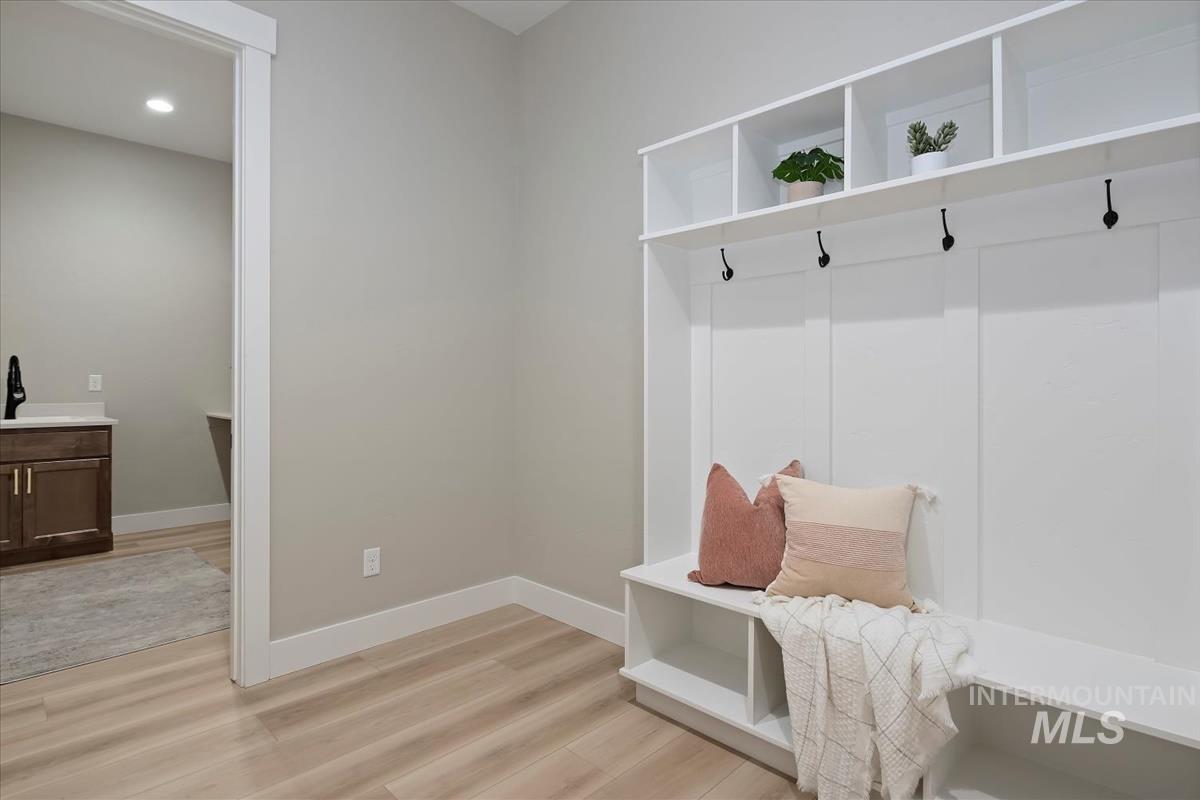 Mudroom with light wood finished floors and recessed lighting