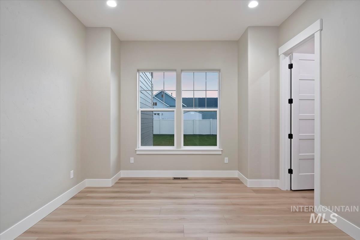 Unfurnished room featuring light wood finished floors and recessed lighting