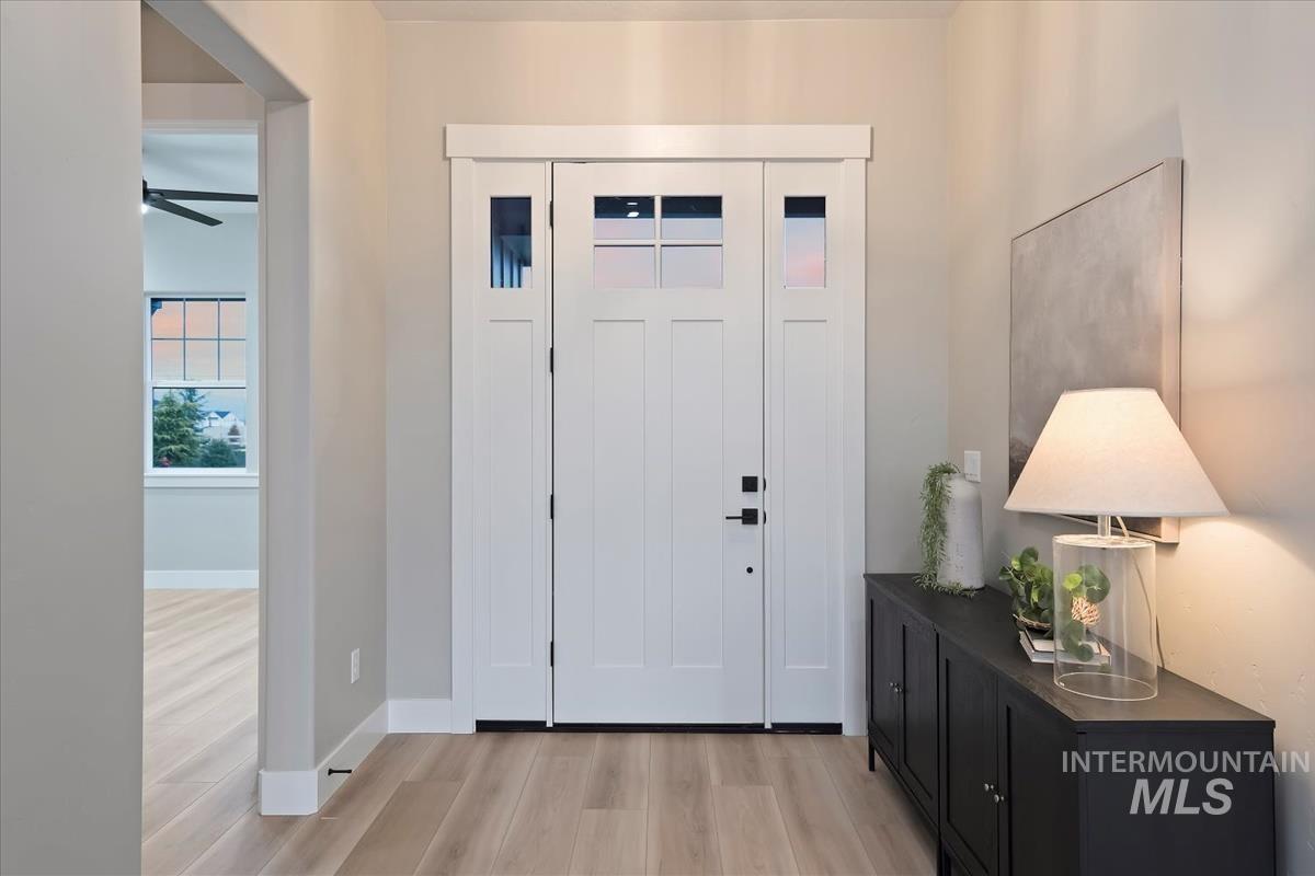 Entryway featuring light wood-type flooring and a ceiling fan