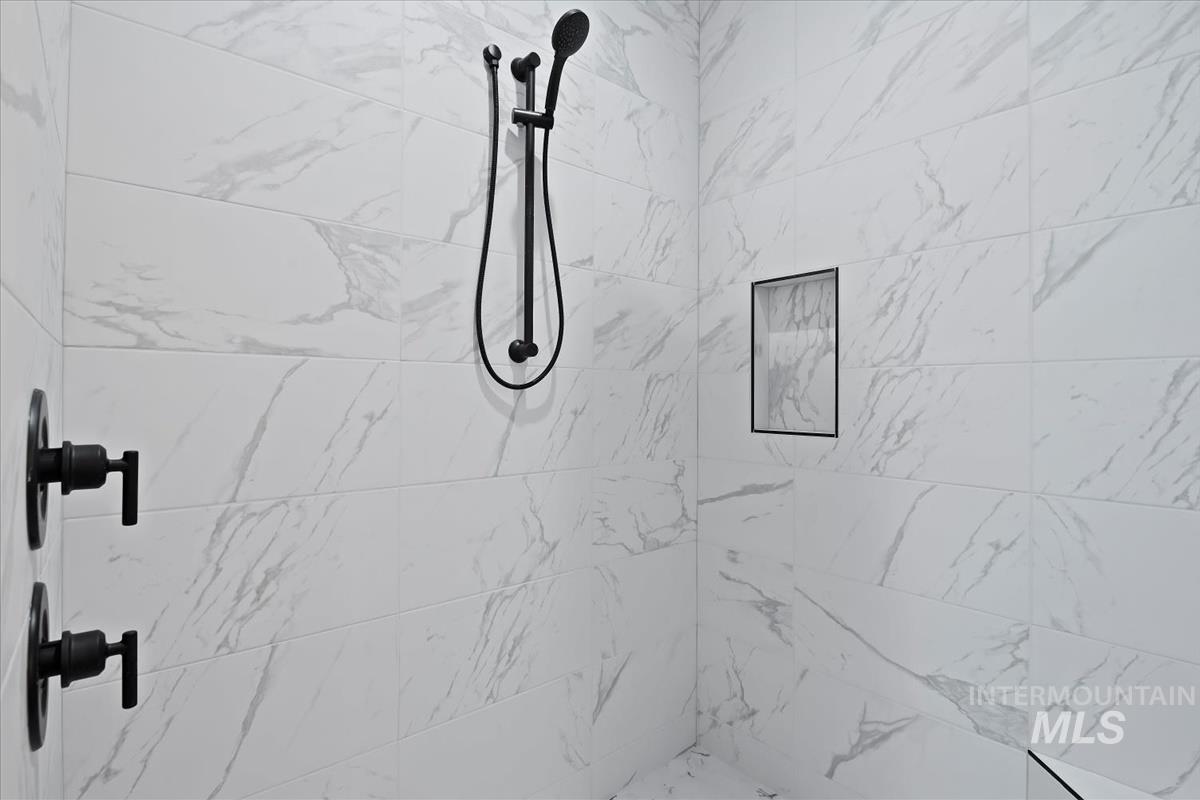 Bathroom view of a marble finish shower